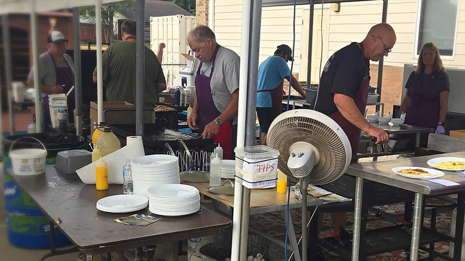 Cooks in the outdoor kitchen fire up their griddles.