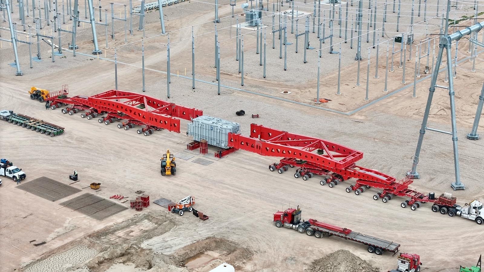 Specialized hauling contractor Omega Morgan is hauling seven transformers from the rail yards in Laramie to PacifiCorp’s Aeolus substation located to the north of Medicine Bow, Wyoming. Above, the transformer has been moved off the longer trailer onto a unit pad as workers get ready to move the electrical system into place at the substation