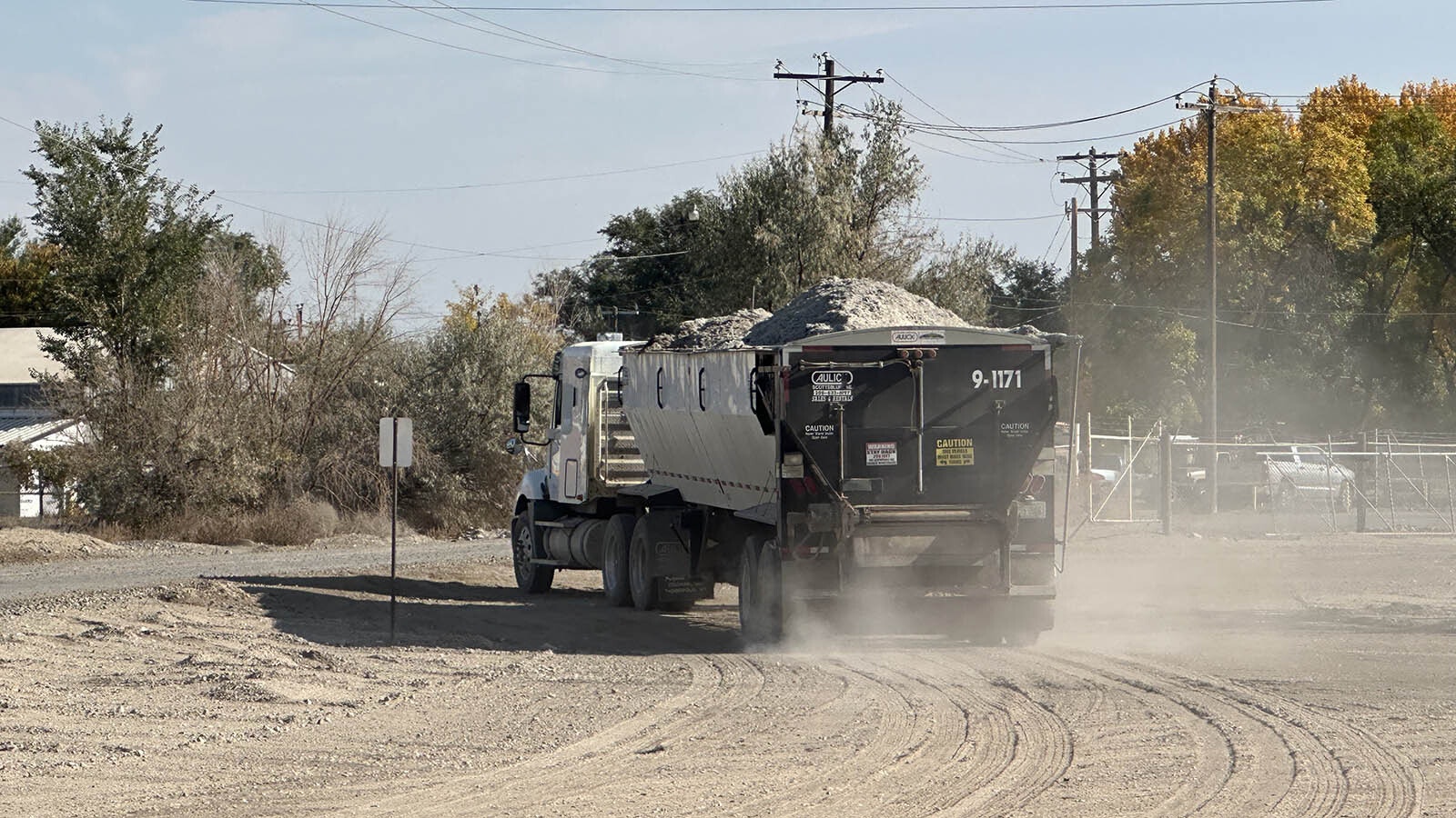 Jim Miller uses the sugar beet pulp, the leftover shreds from sugar processing, as feed for his sheep. With the afternoon heat arriving early, deliveries have ended for the day and he is taking his last load home to the family farm.