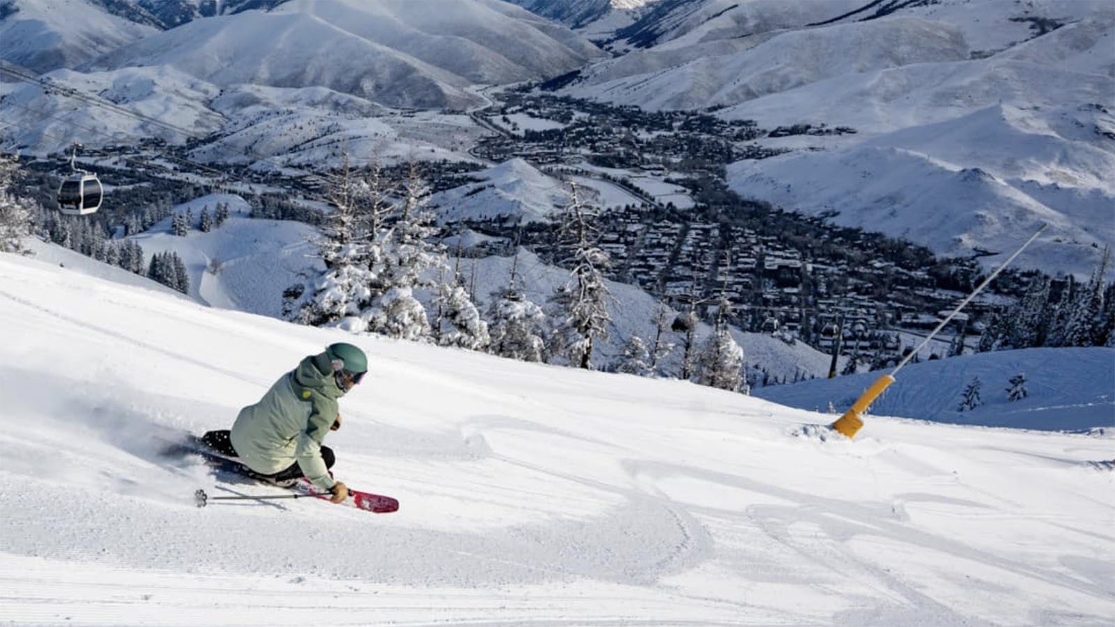 A skier navigates a groomed run outfitted with a tower-nozzle snow gun and yellow padding at Sun Valley Resort. In 2019, a skier hit one of these snow guns and died, and now a lawsuit over his death could impact the ski industry in Idaho and beyond.