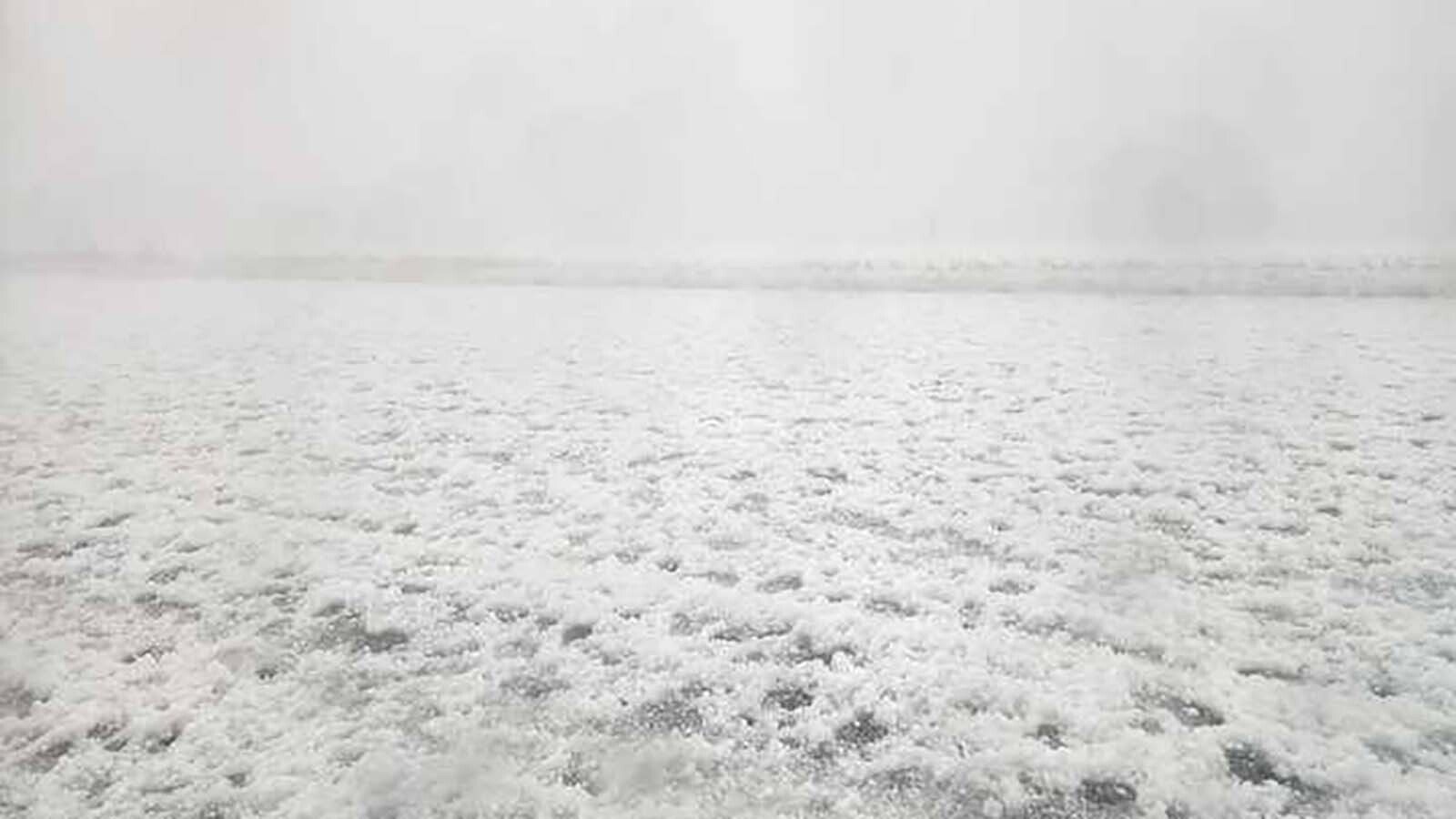 Hail blankets the ground and vehicles like a snowstorm Thursday in eastern Wyoming. A supercell thunderstorm brought volatile weather, including hail, which was reported to be softball-sized in some areas.