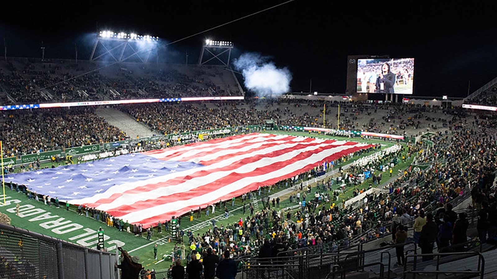 This superflag, a huge 160-foot by 300-foot American flag unfurled at the Border War football game Friday took 200 people to carry.