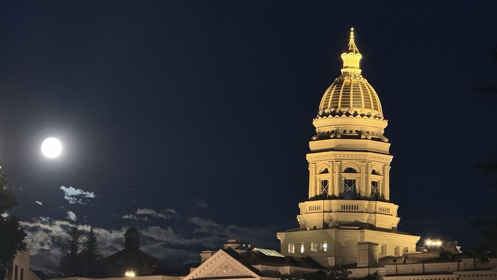 A supermoon shines bright over the shoulder of the Wyoming Capitol in Cheyenne on Tuesday night, Sept. 17, 2024.