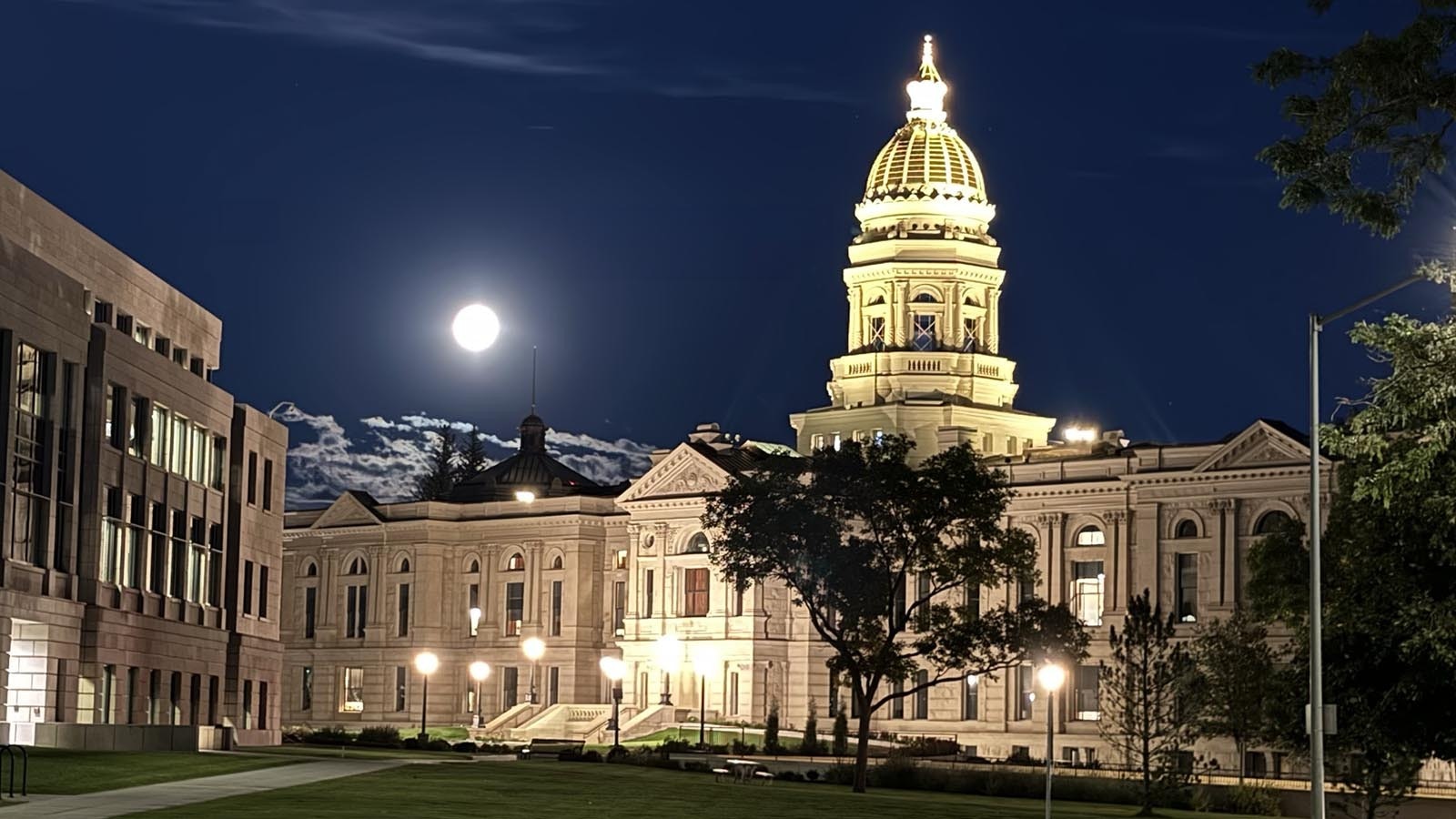 A supermoon shines bright over the shoulder of the Wyoming Capitol in Cheyenne on Tuesday night, Sept. 17, 2024.