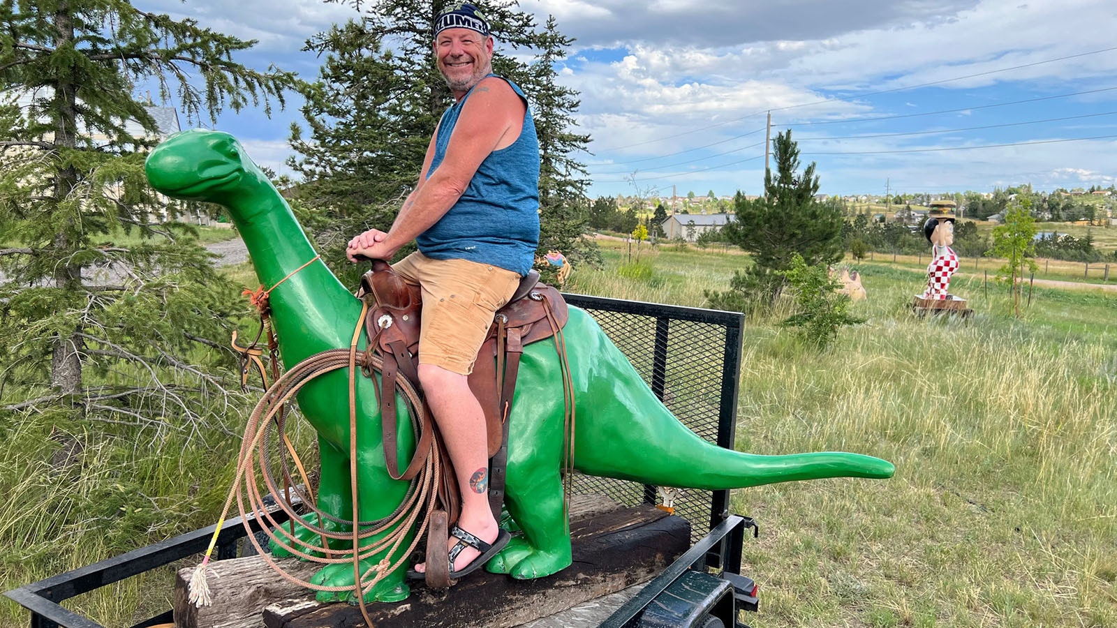 Stuart Flynn lets kids sit in the saddle of his Sinclair dinosaur, Dino.