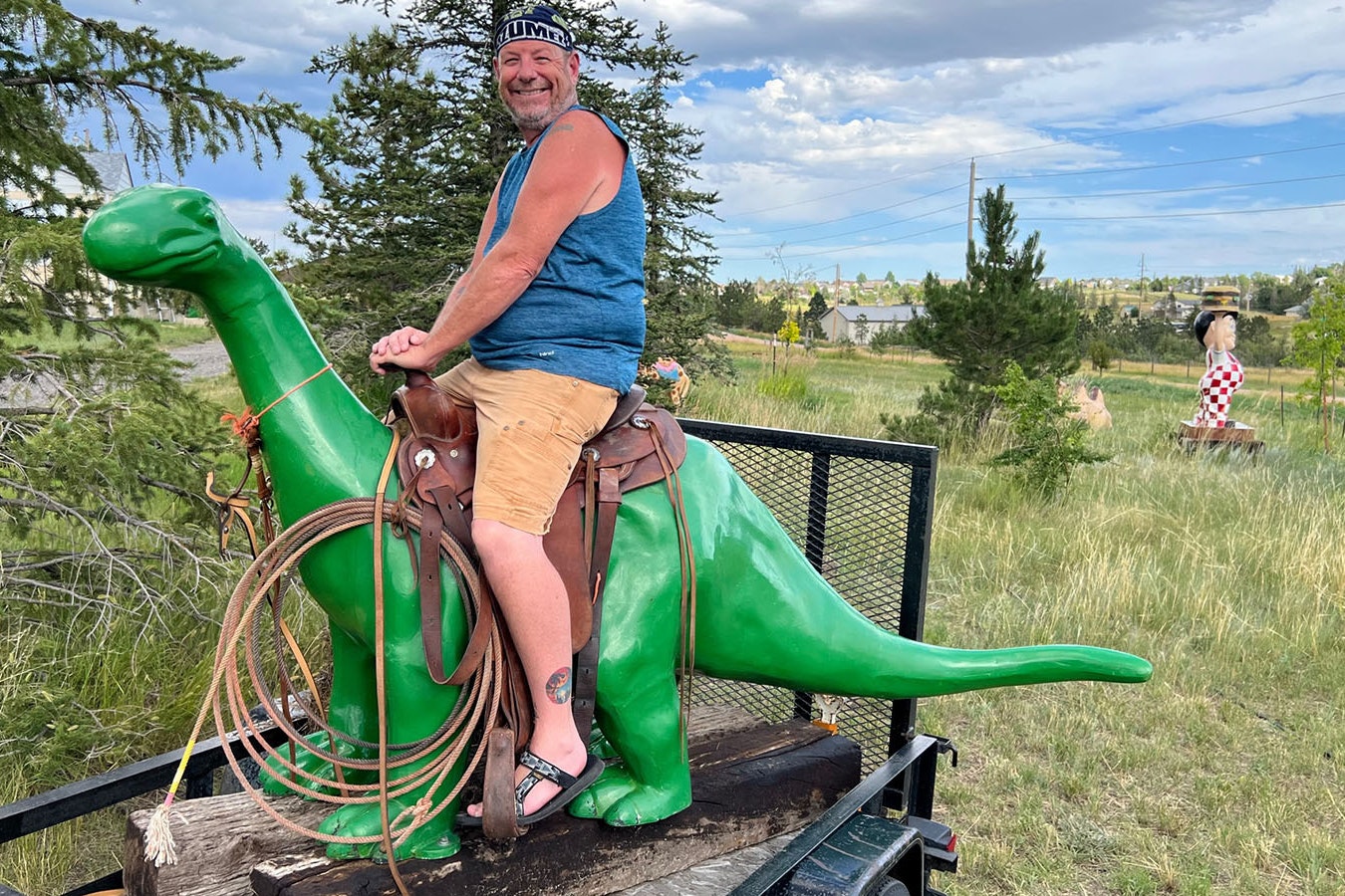 Stuart Flynn lets kids sit in the saddle of his Sinclair dinosaur, Dino.