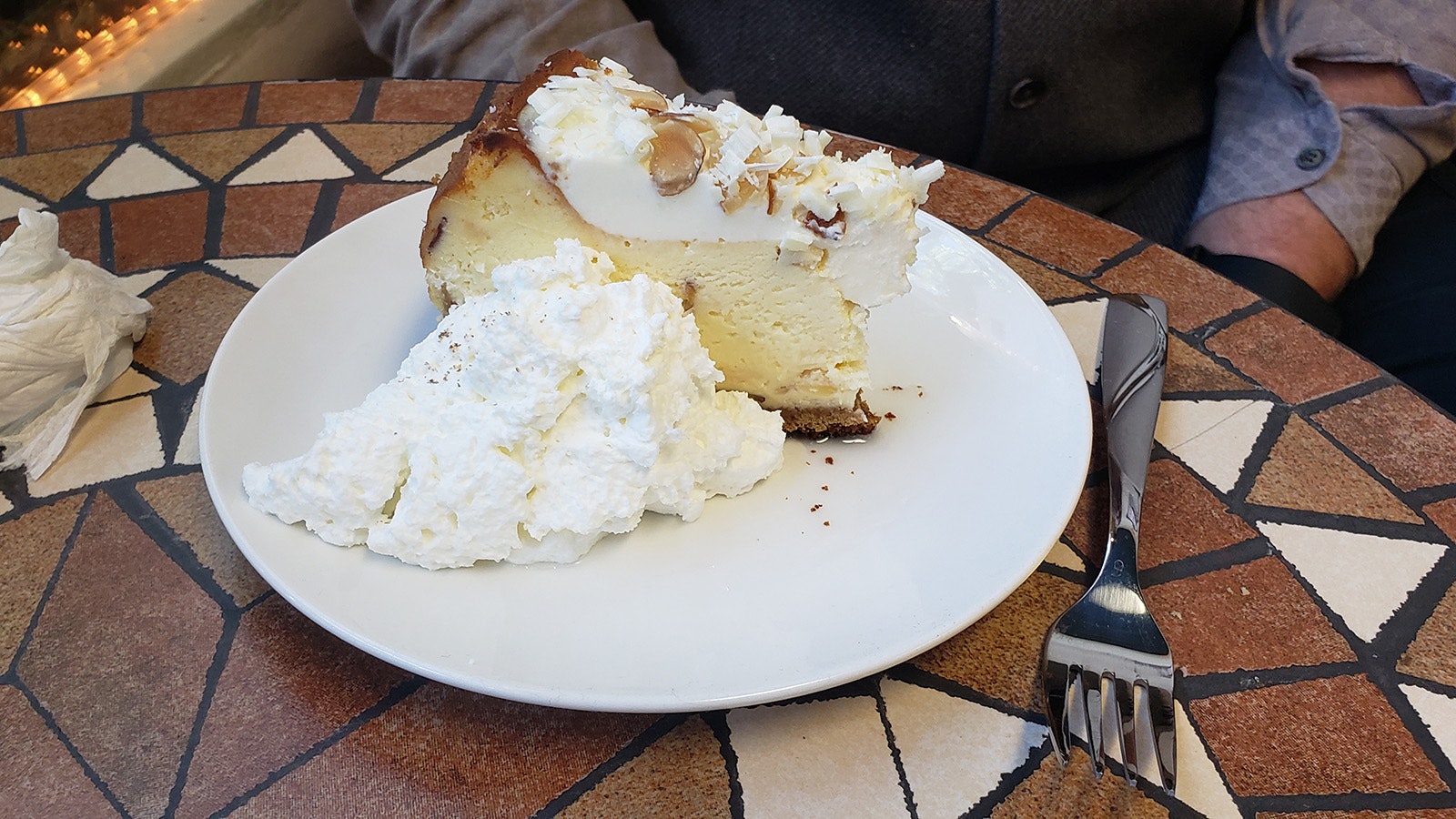 A slice of amaretto white chocolate cheesecake.