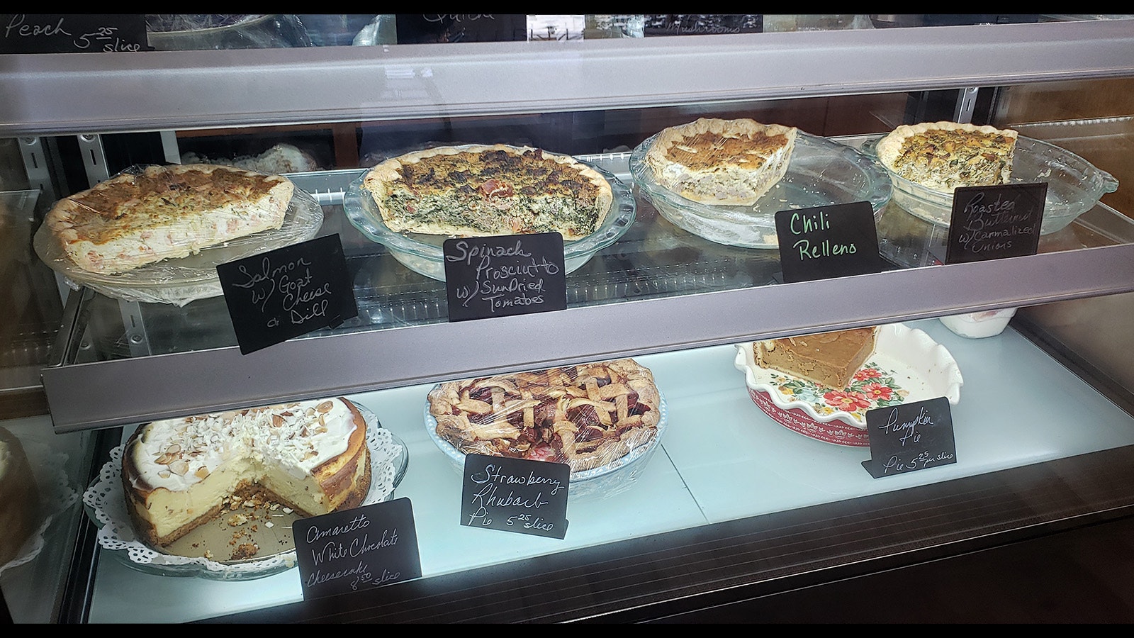 Quiche and pies in the display case.
