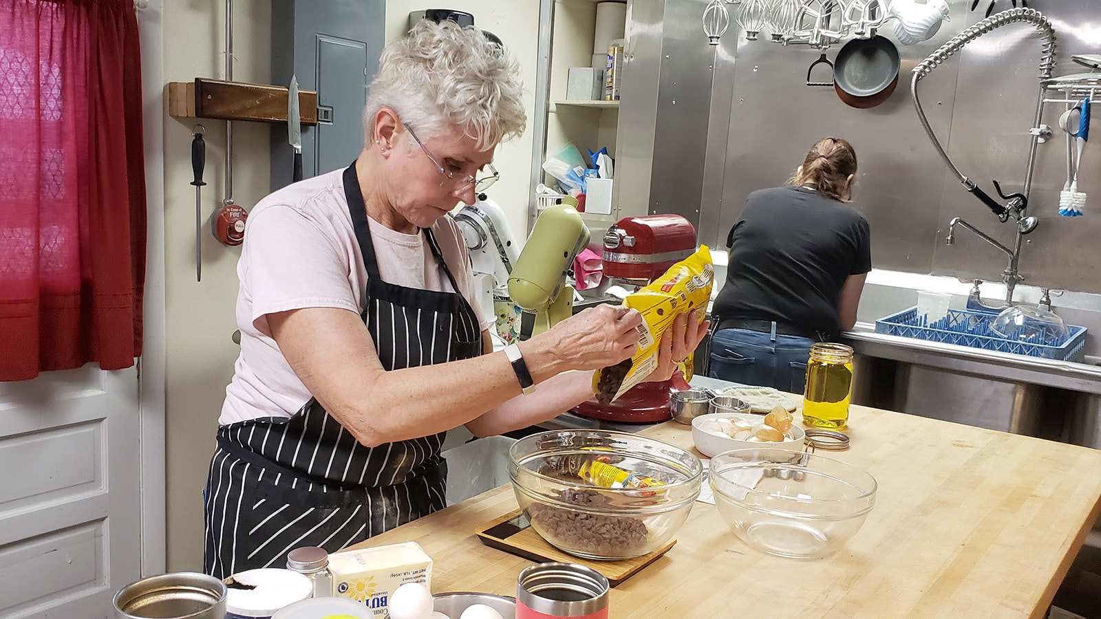 Ronni Roemmich makes a batch of brownies in the kitchen at Sweet Surprises.