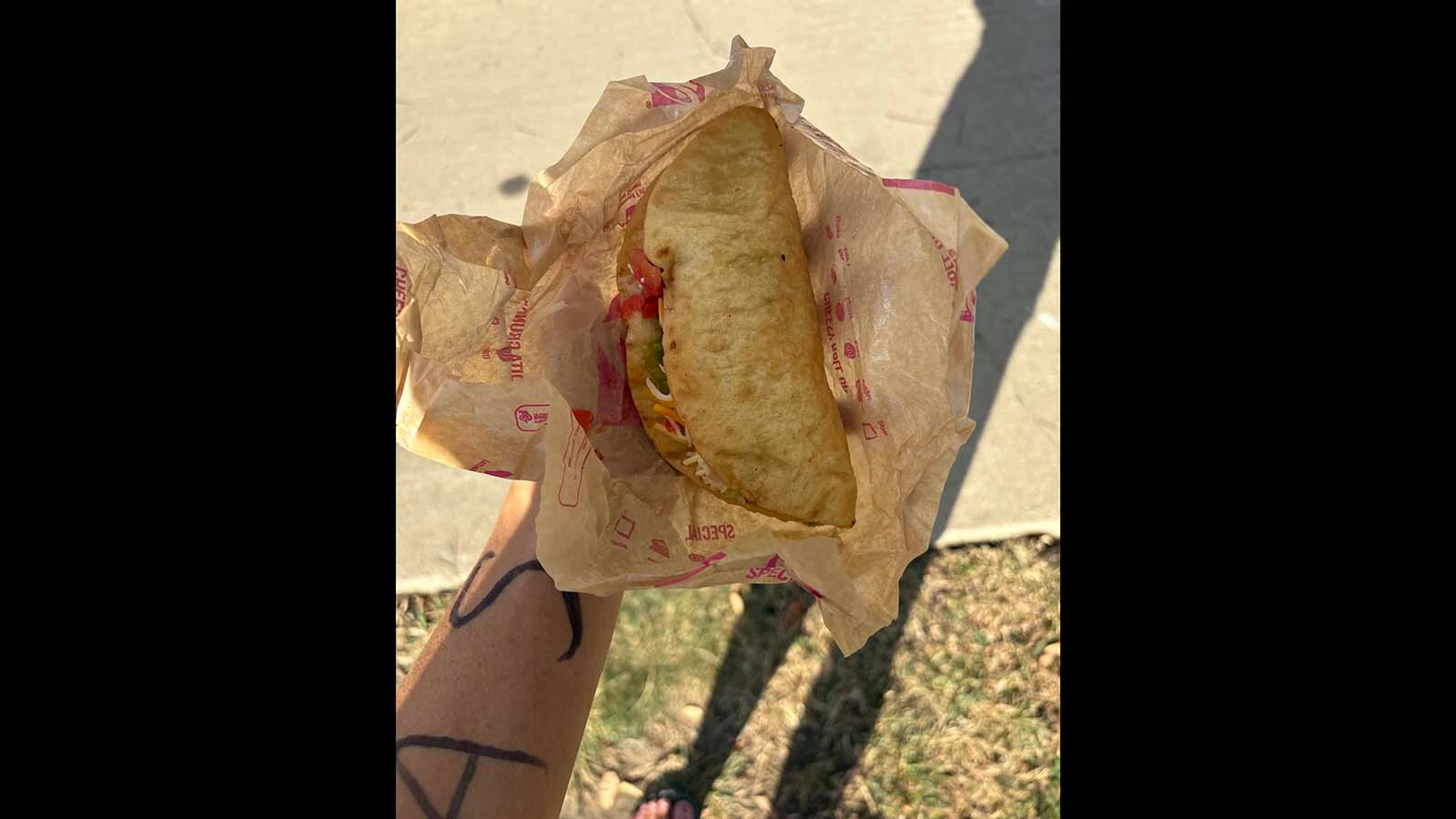 Clair McFarland eats a Chalupa Supreme at Taco Bell No. 4, during the Oct.3, 2026 Taco Bell 50K ultramarathon. Runners were required to eat at 10 Taco Bells in 31 miles without vomiting.