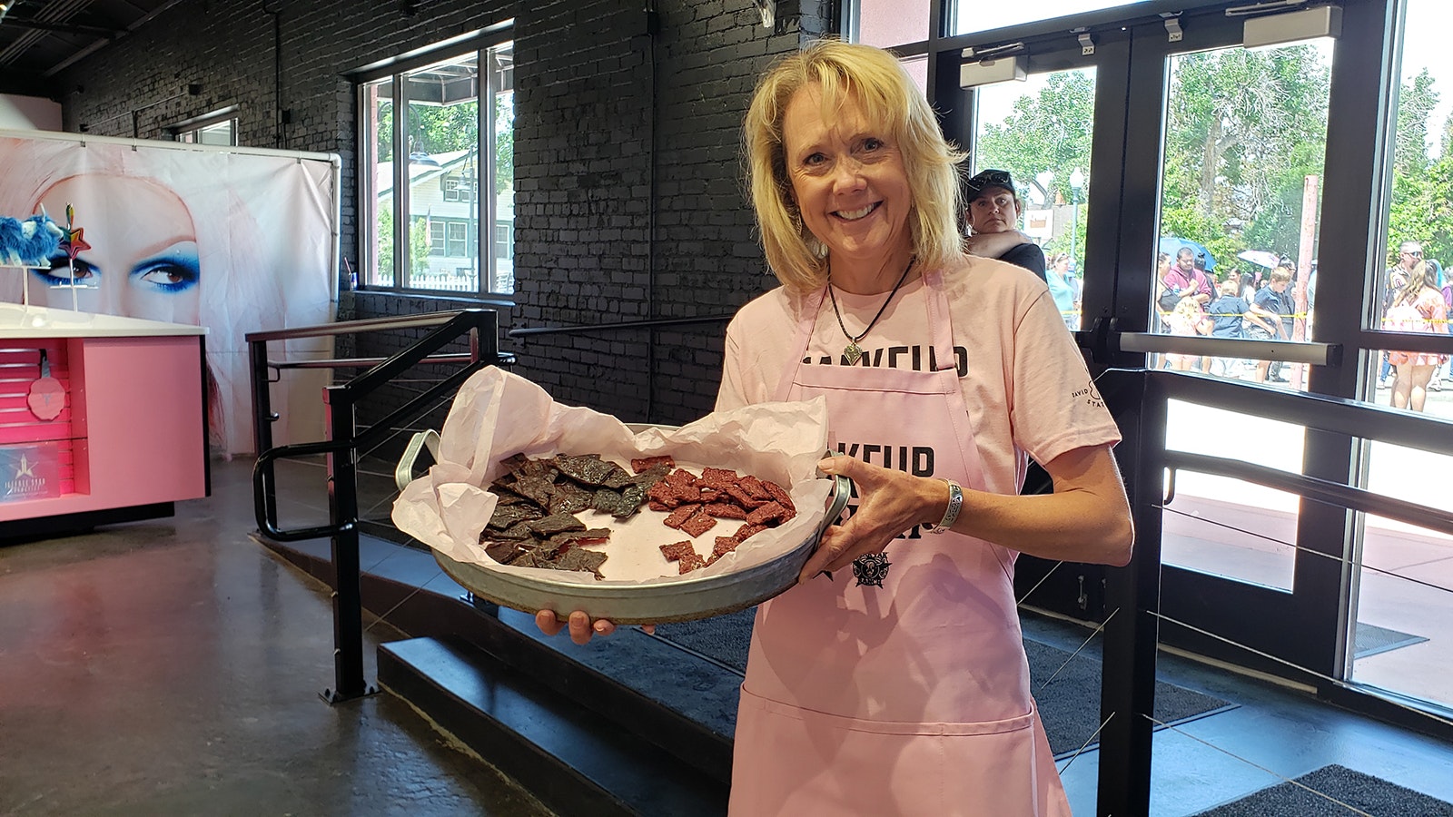 Kim De Vore, CEO of Jonah Bank, was among volunteers helping out at the Jeffree Star store's grand opening. She was serving samples of his ranch's yak meat.