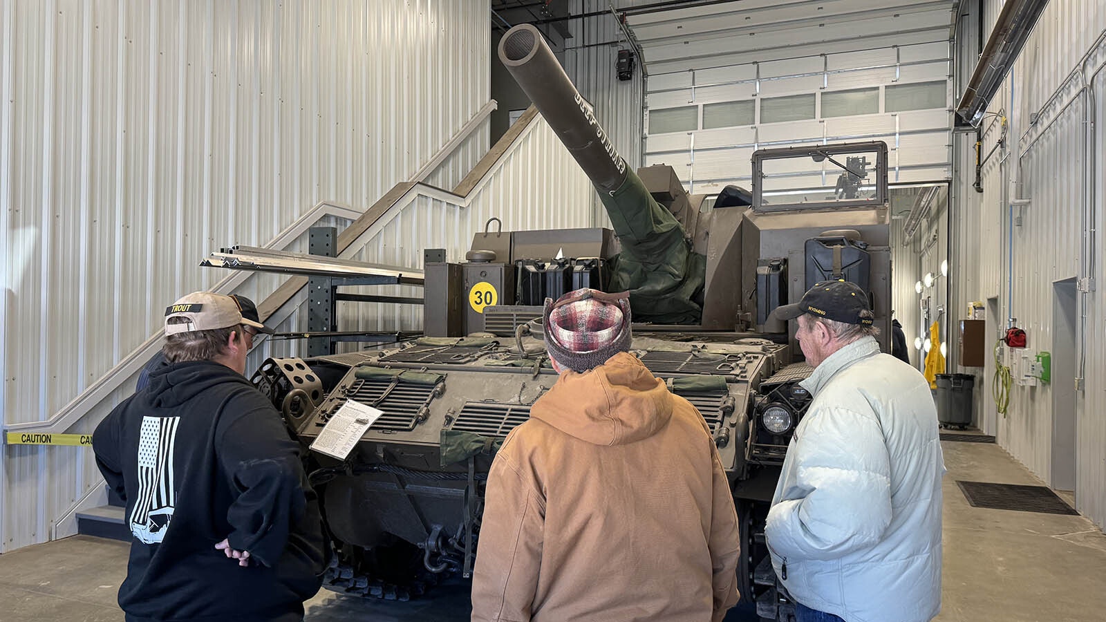 Visitors admire an M44 self-propelled howitzer in the facility's 700-square-foot wash bay.