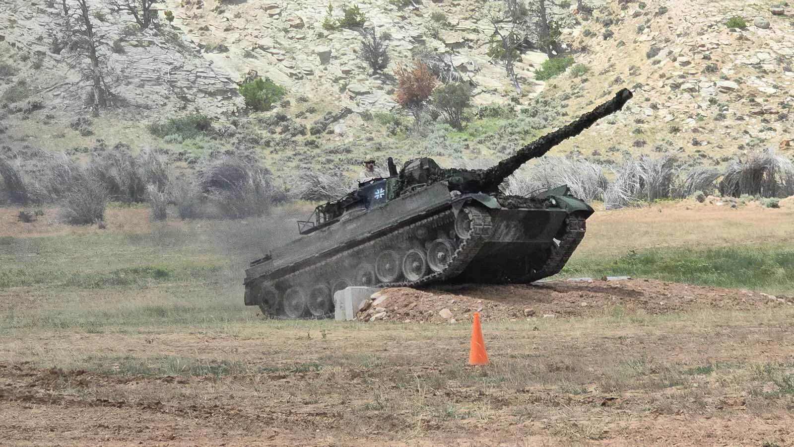 Up and over — a Leopard tank has no trouble climbing a 2-foot cinderblock wall in an obstacle course built to demonstrate the capability of that tank and a Sherman M4.