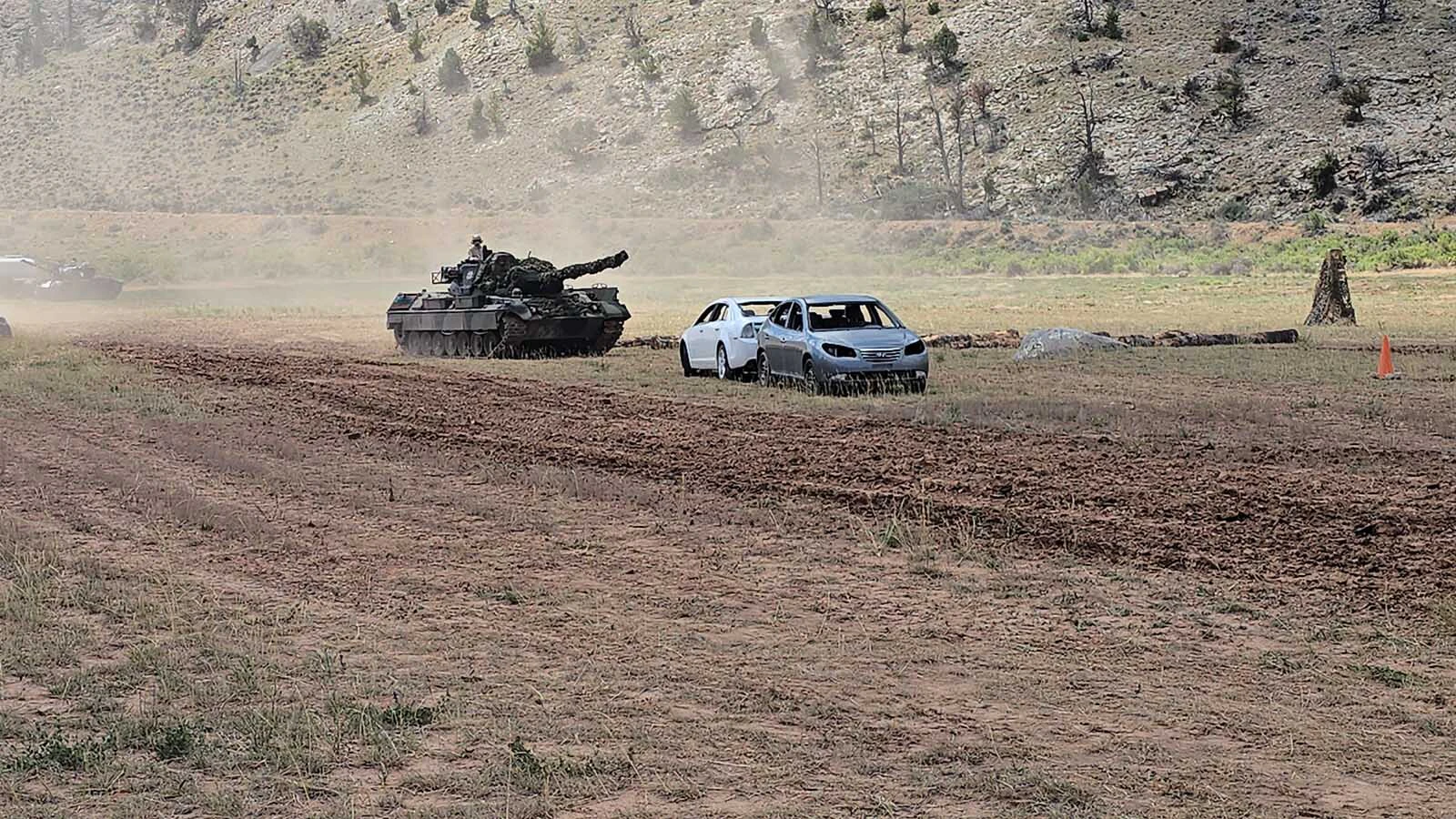Two cars stand in this 1981 Leopard tank's way.