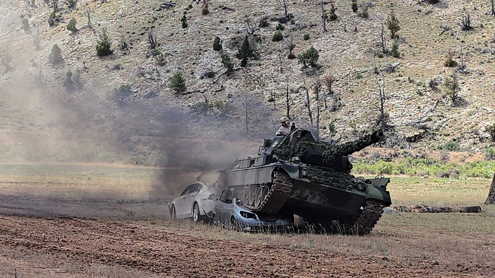 The cars are easily crushed by the weight of the 42-ton tank.