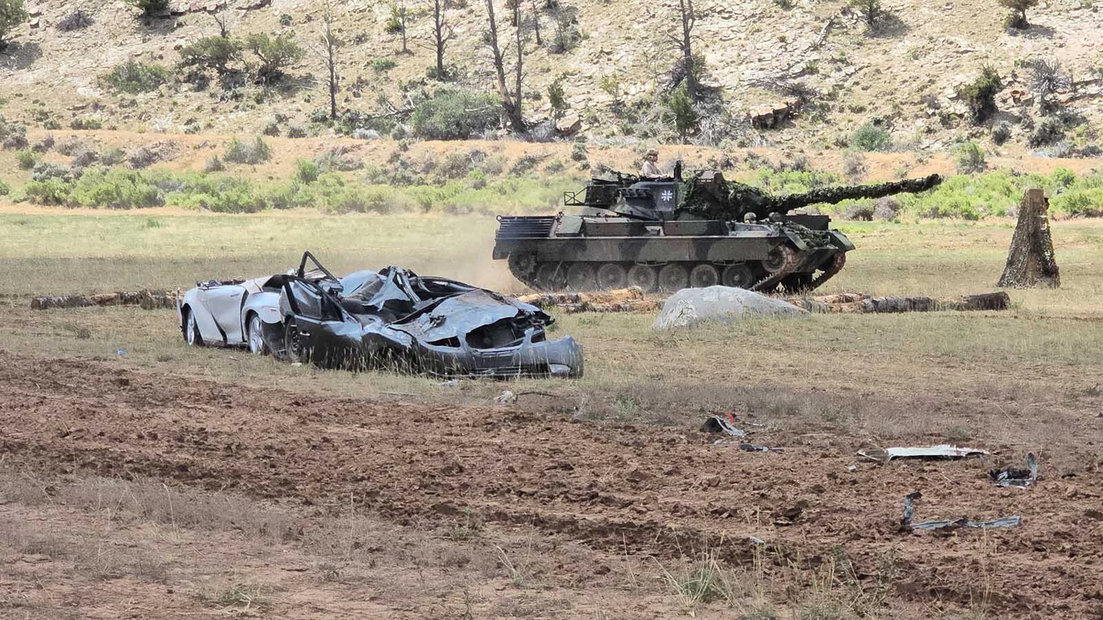 Two easily crushed cars after just a few passes with a tank.