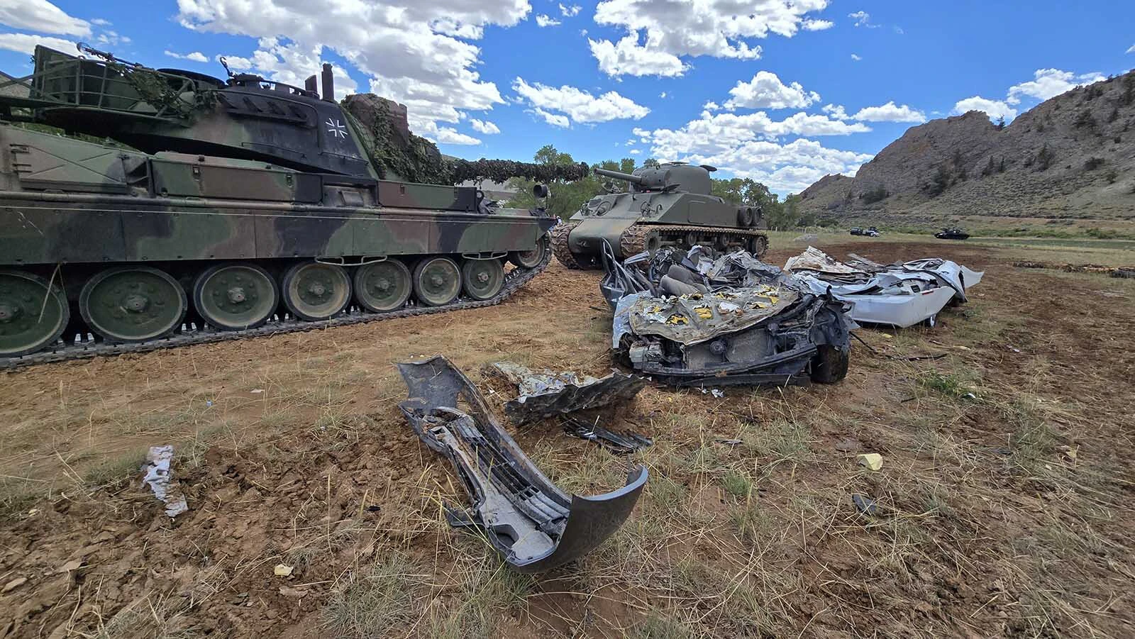 A Leopard tank, left, and an M4 Sherman Tank, right, made short work of these two vehicles. The two drivers said they barely felt anything rolling over these two cars.