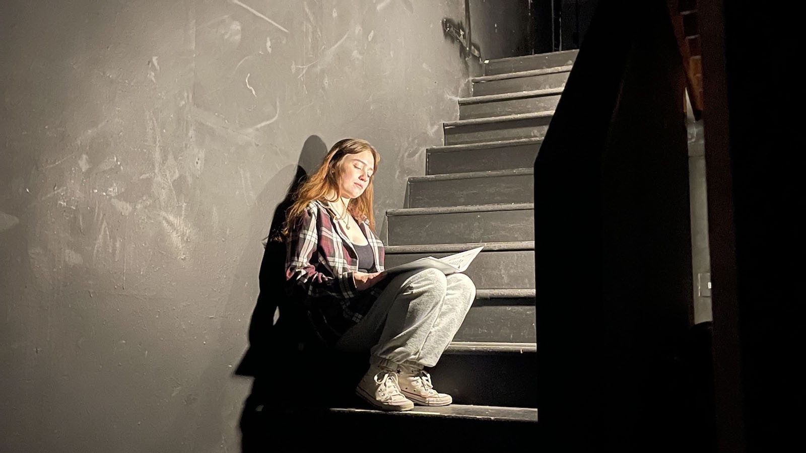 Tatum Graham (as Mardy Murie), a senior at Jackson Hole High School, reads through her lines offstage during rehearsal.