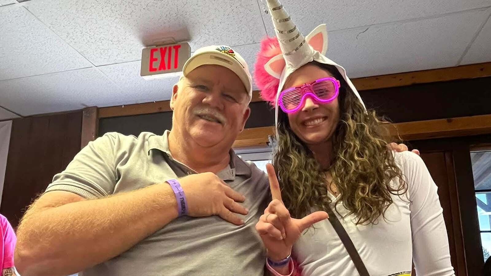 Eric Crock with his friend and former student Rhianna Brand, flashing Crock's familiar 4 Life sign that signifies they're friends long after school ends.