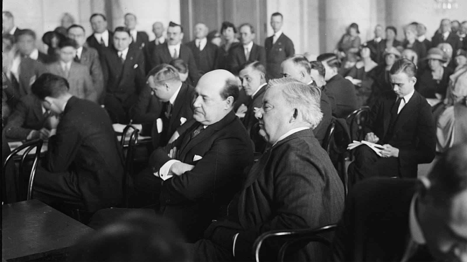 Oil baron Harry Sinclair, center with arms folded, sits in a congressional hearing on the Teapot Dome scandal.