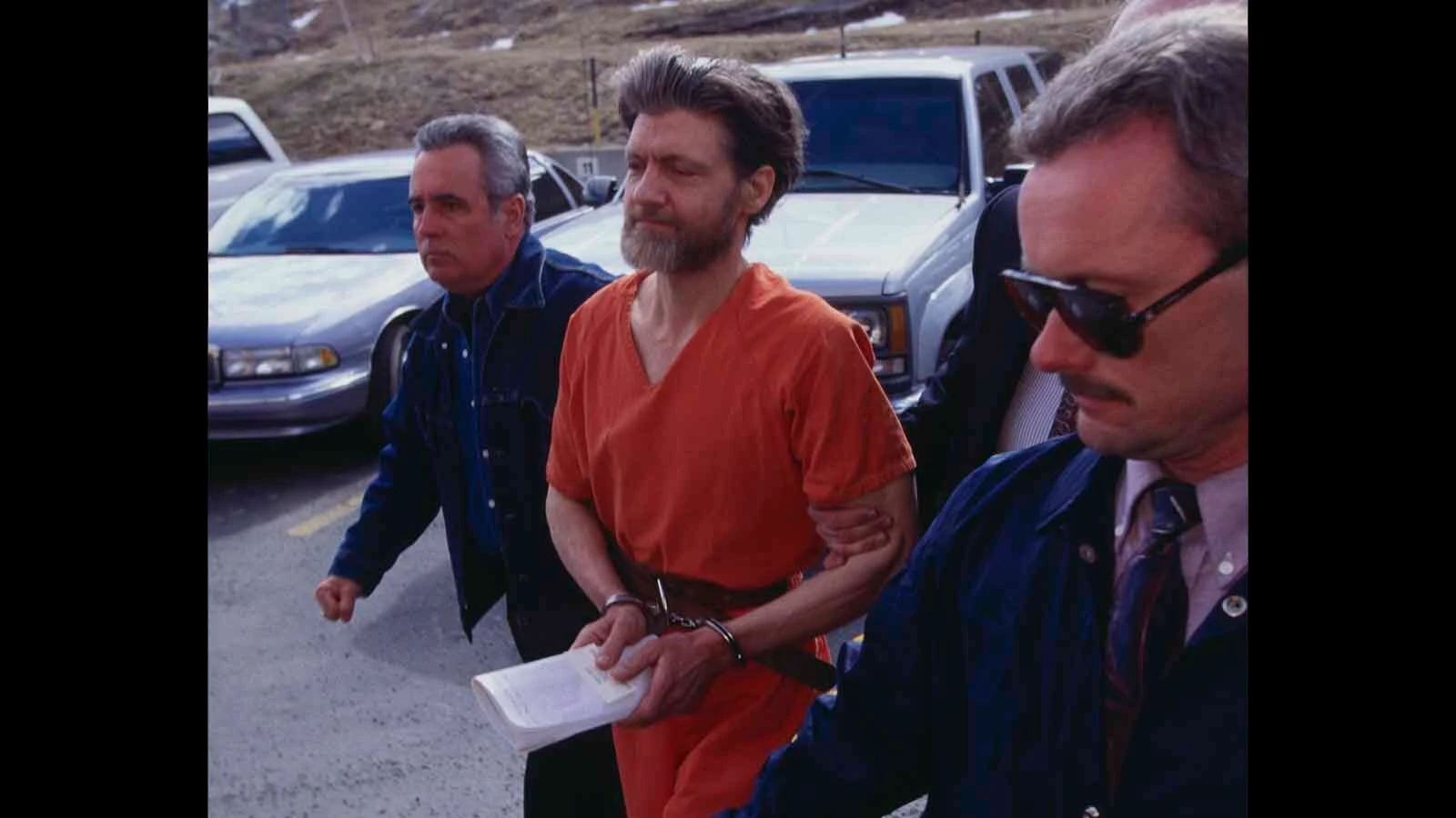 Police officers bring Theodore Kaczynski, aka the Unabomber, to court for arraignment, April 4, 1996. Kaczynski later pleaded guilty to the mail bomb attacks that killed three people and injured 23.