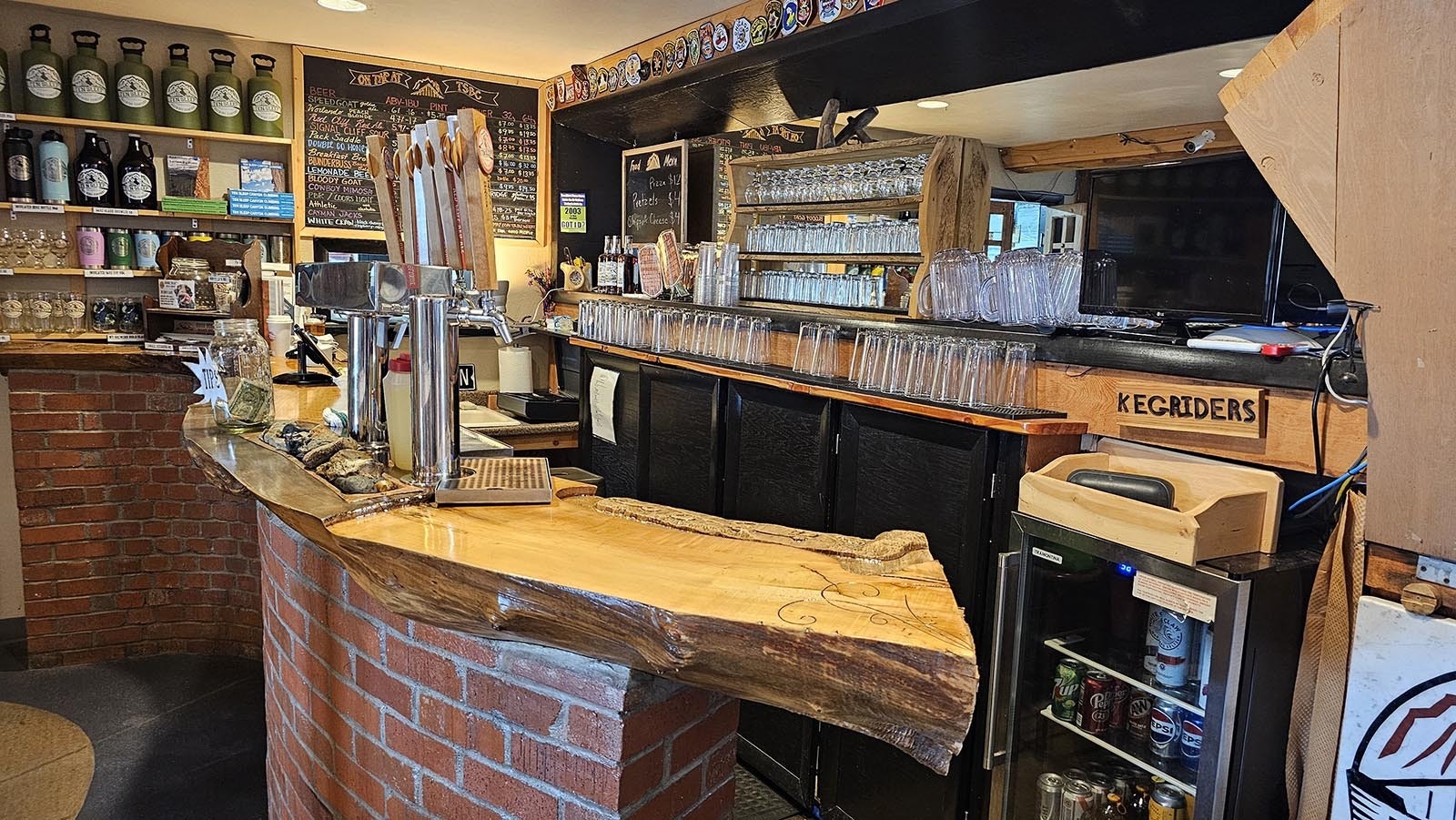 The bar is a curved piece of wood that was already that shape when it was cut down. The family had the piece of wood on their ranch, and repurposed it for a bar at Ten Sleep Brewery.
