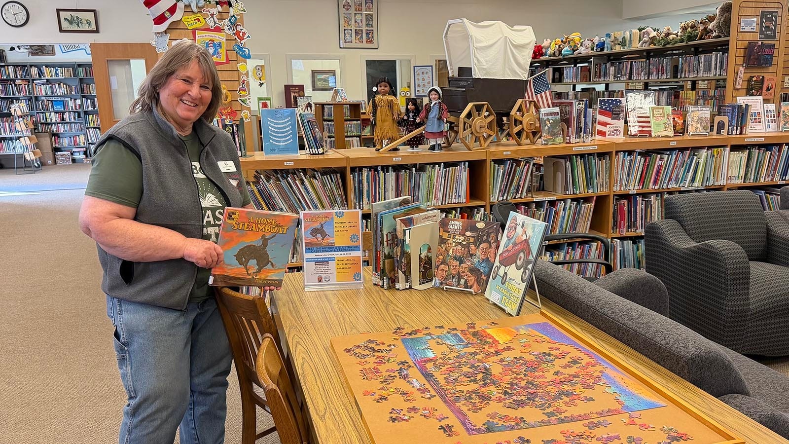 Carol Greet holds a book for an upcoming author visit. The Ten Sleep Branch Library recently won a prestigious national library award for their work in their small rural community.
