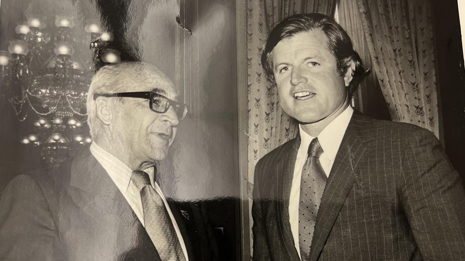 Teno Roncalio, left, and Ted Kennedy talk during an event.