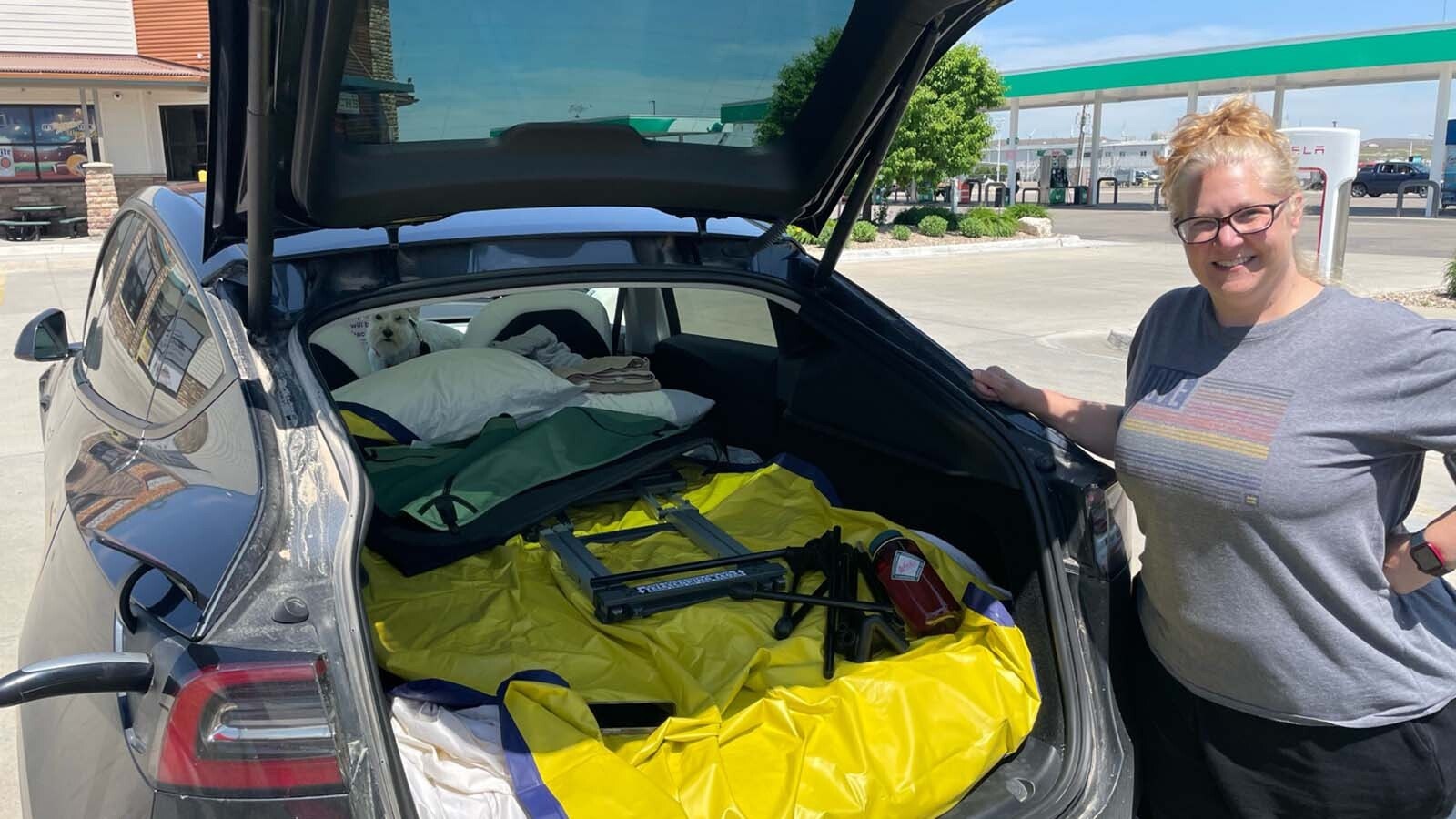 Alison Streeter organizes her road trip gear before hitting the road headed west in her Tesla.