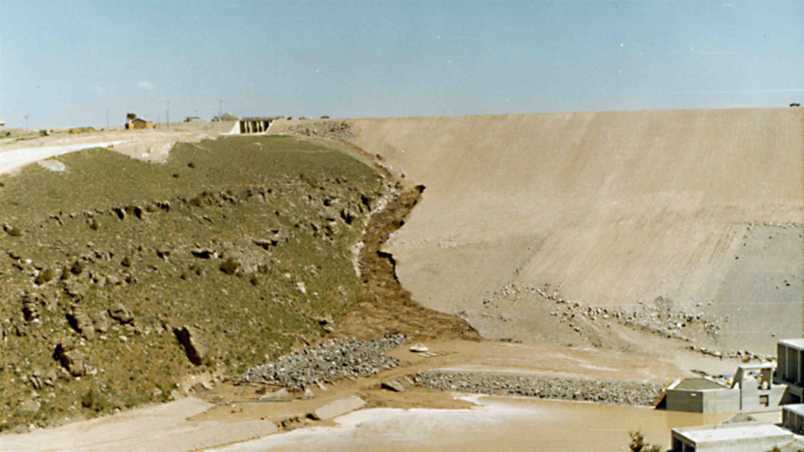 Photos taken at the time of the Teton Dam disaster show how water started leaking and then waters surging through the dam site.