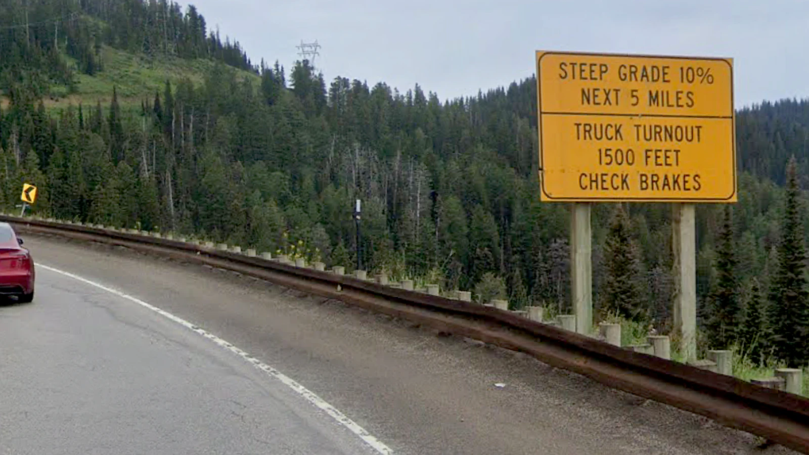 A warning sign on Wyoming Highway 22 over Teton Pass outling steep 10% grades ahead.