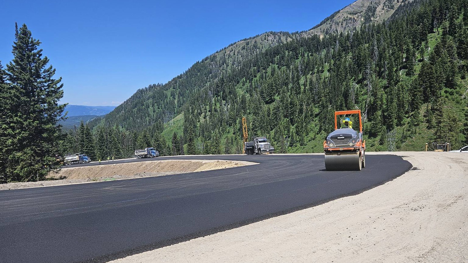 Paving on a workaround to a catastrophic failure of a section of Highway 22 over Teton Pass began Tuesday, less than three weeks after the slide.