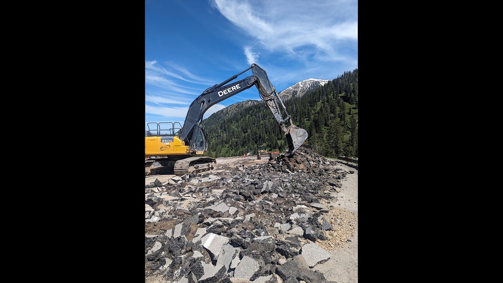 A crew from Evans Construction works on the temporary detour on Teton Pass at milepost 12.8, which had a catastrophic failure Saturday.