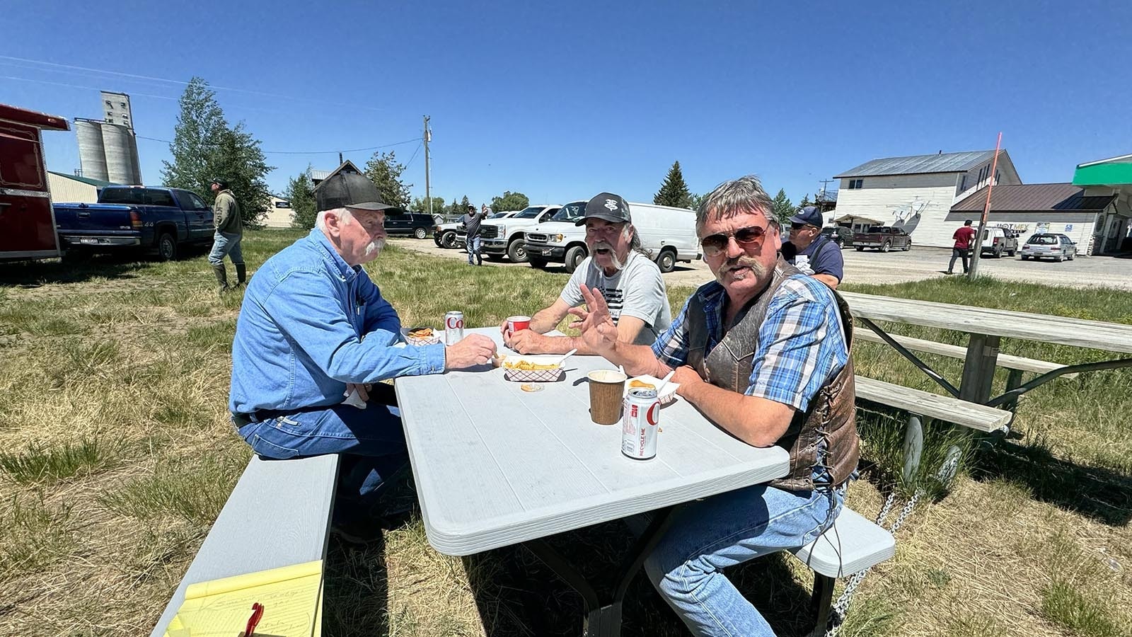 Above from left, Os Rigby, Hank Hatch and Jim Beard, ate hamburgers at a picnic table outside the Hot Diggity Dog food stand in Tetonia, Idaho, chewing the fat on the traffic mess in the Teton Valley. They wondered why WYDOT wasn’t helping out with the grading on the old Reclamation Road that runs up near Grassy Lake Dam in Wyoming by the southern boundary of Yellowstone National Park.