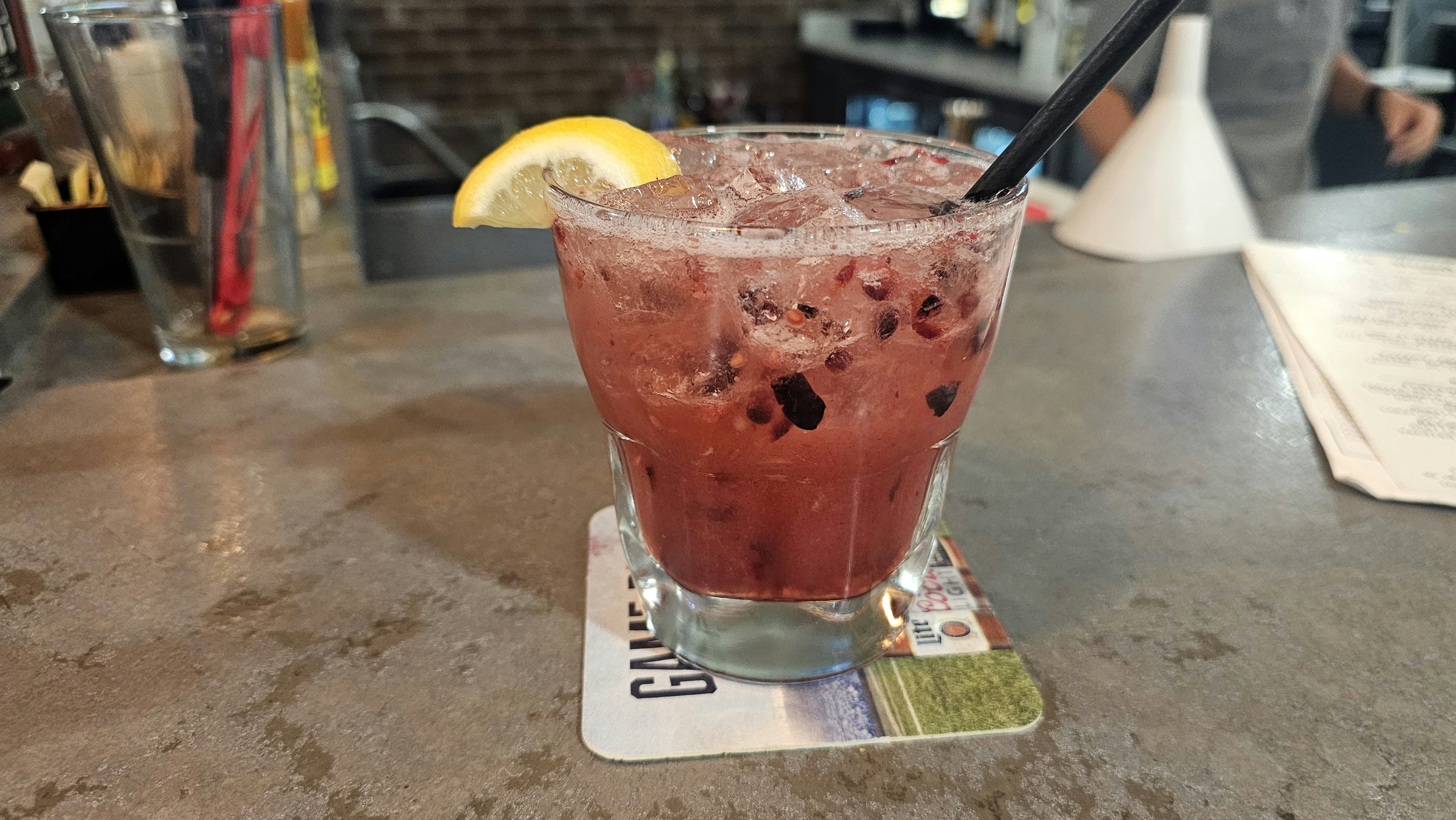 A cocktail called Pure Joy available at Alibi Wood Fire Pizzaria. It tastes like a fresh southern lemonade, with clouds of fresh berries floating in the glass.