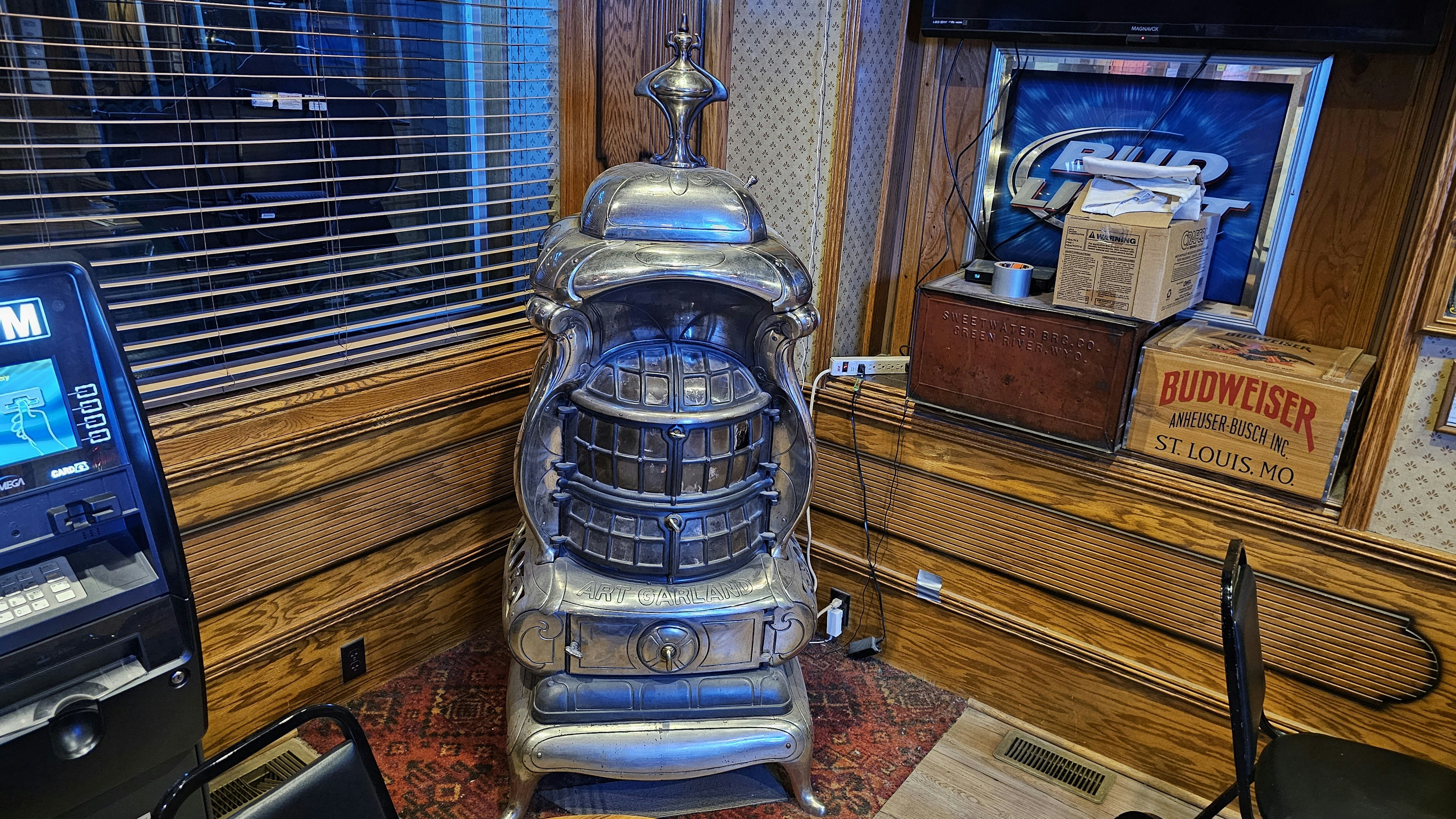 An old stove in the corner, along with old crates that used to hold beer.