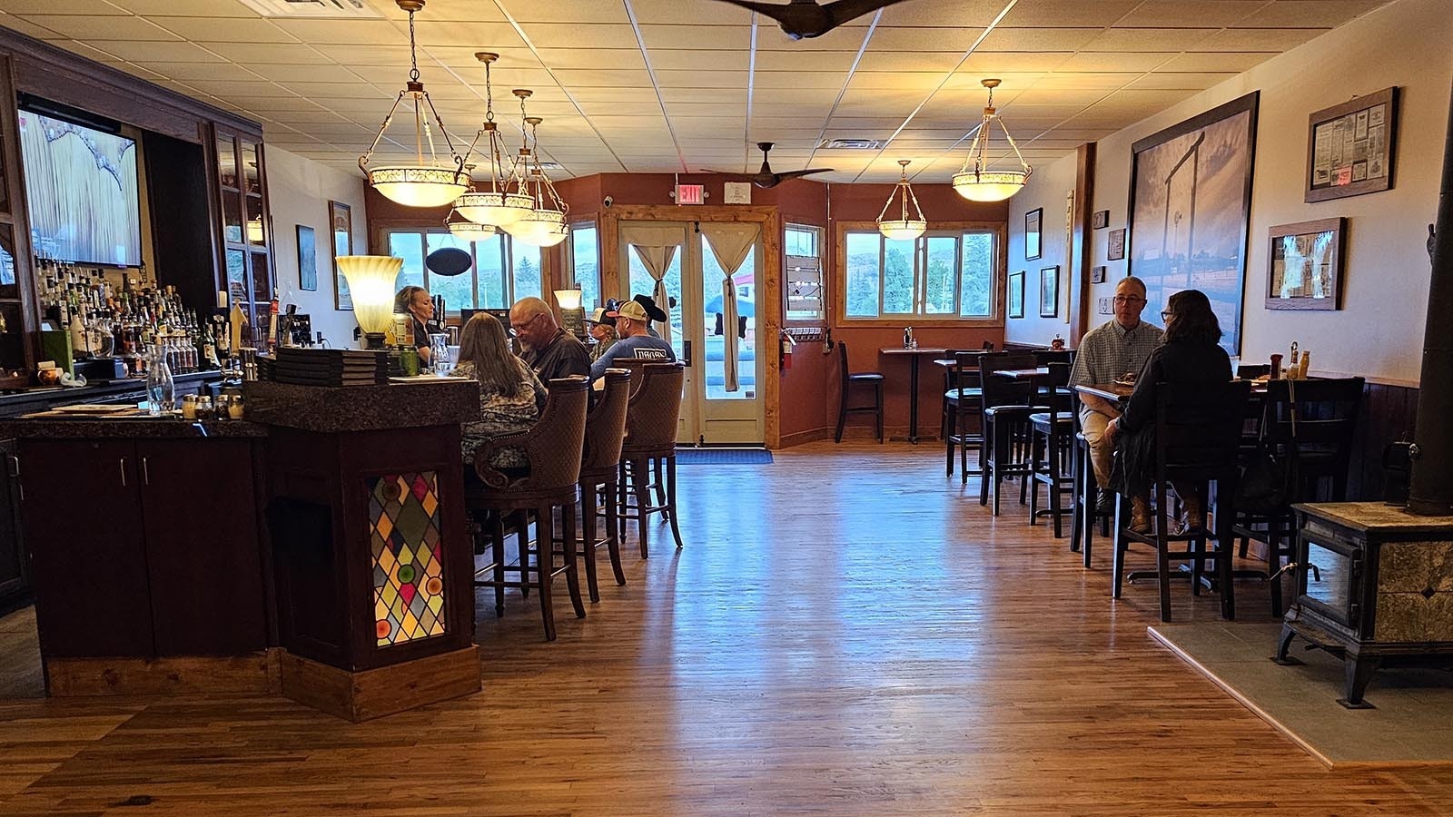 Wooden floors and dark wood make The Divide Restaurant & Lounge feel cozy.