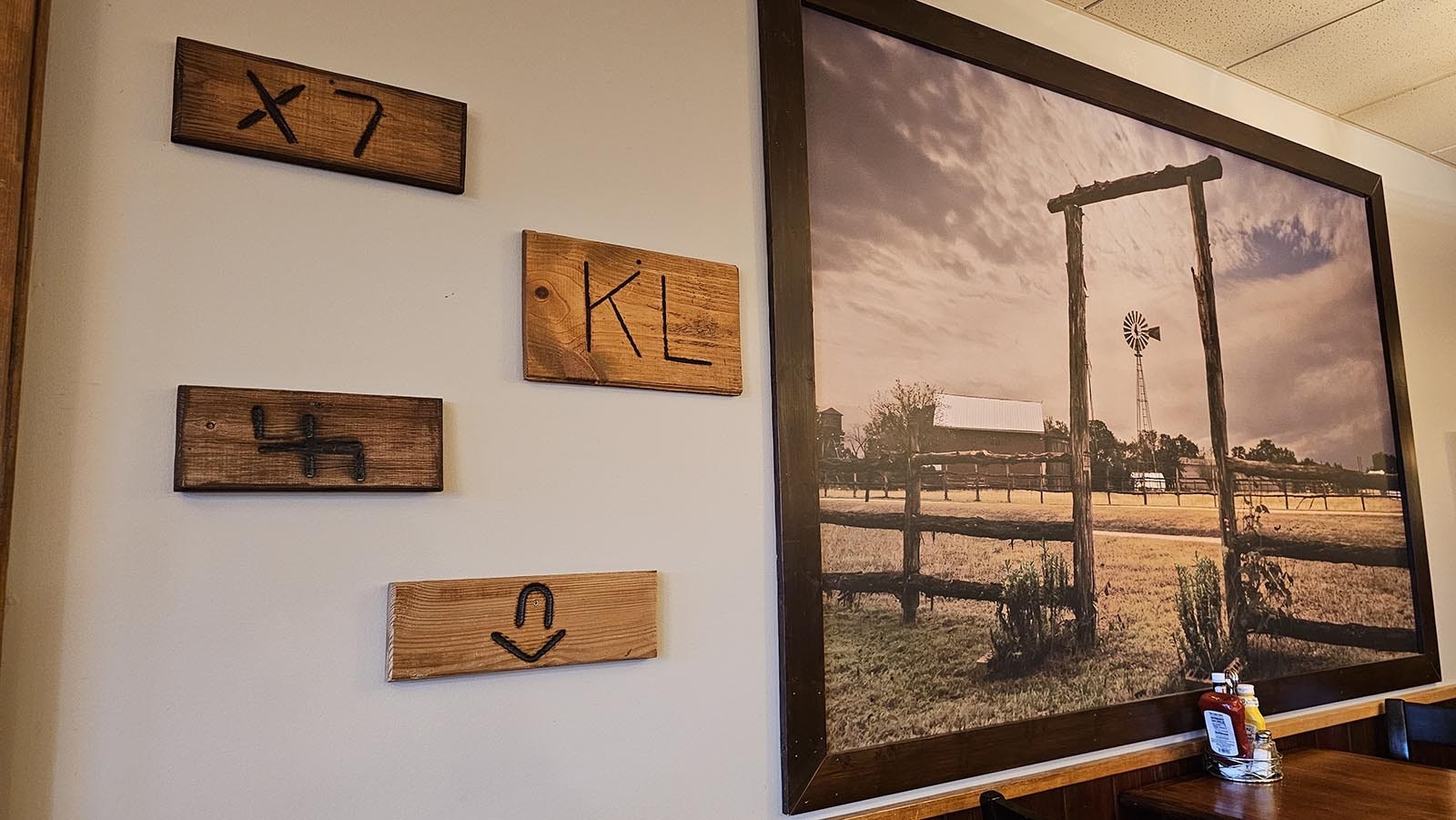 Brands from the Encampment area on the wall at The Divide Restaurant & Lounge.