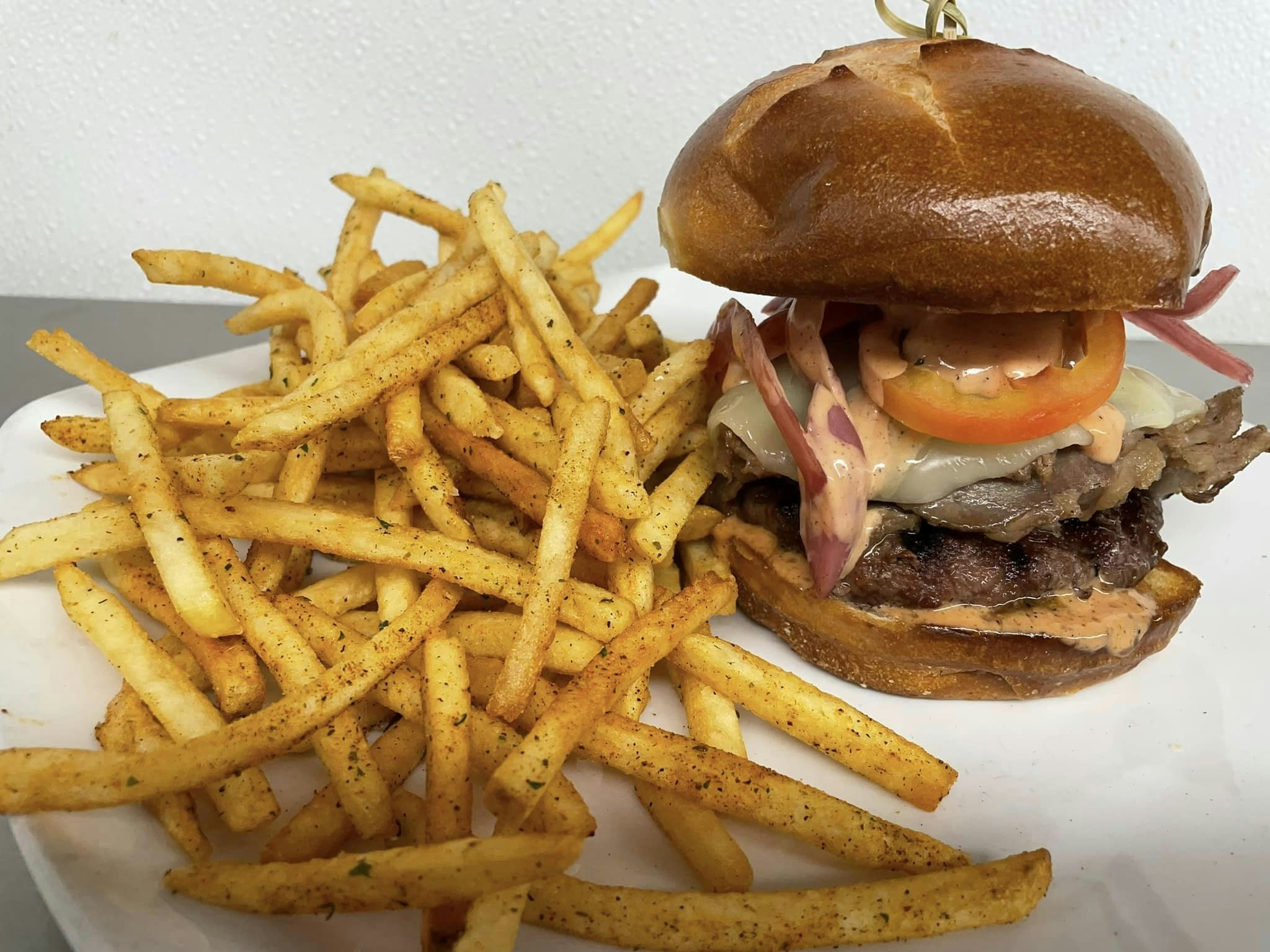 Burger and seasoned fries.