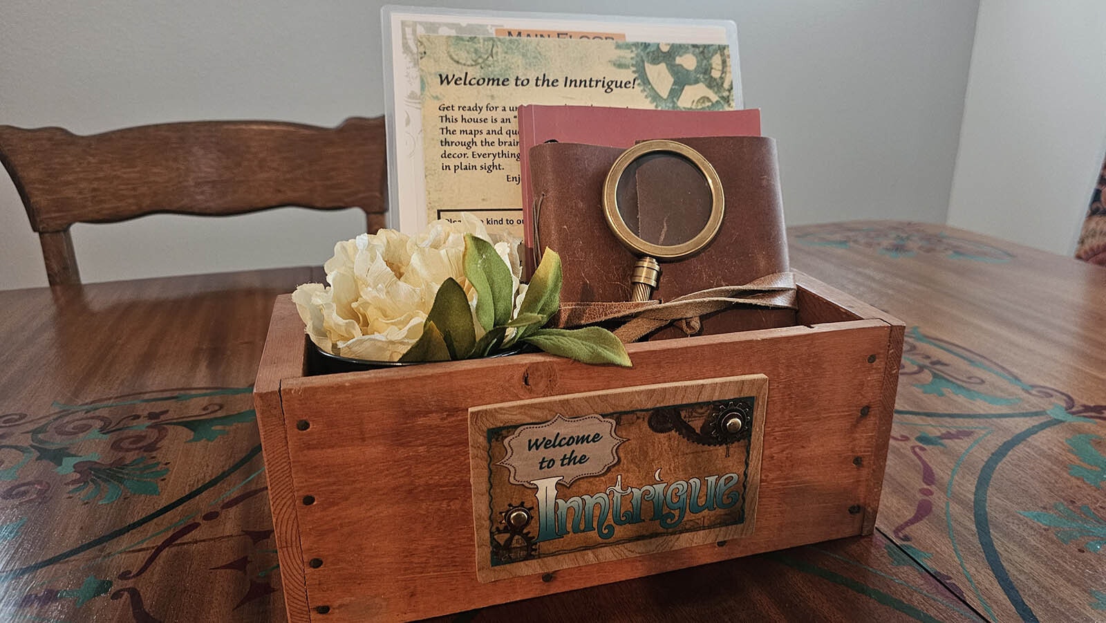 A welcome box that explains the House of Inntrigue concept serves as the centerpiece for the dining room table.