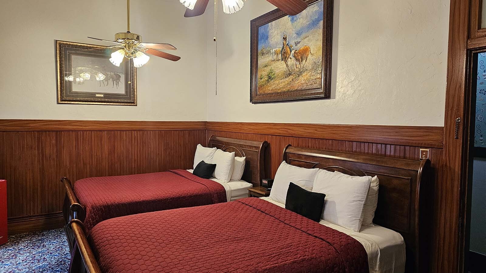 Two queen beds in the Jakie Schwoob Room. Booking specific rooms isn't allowed, but the Irma Hotel website does have historical information about each room.