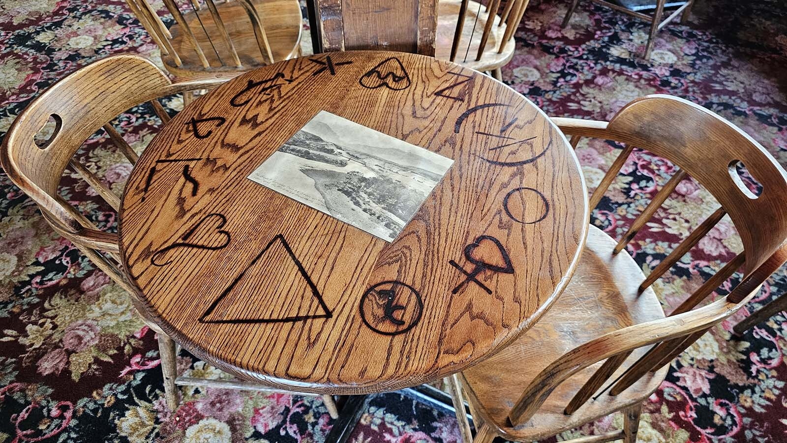 Tables in the saloon have been marked with historic brands, and have historic photographs laminated on them.