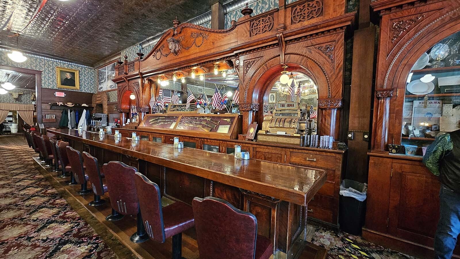 The cherry wood bar and backbar, believed to have been sent to Buffalo Bill Cody as a gift from Queen Victoria, by way of France, New York, Montana, and then Wyoming.