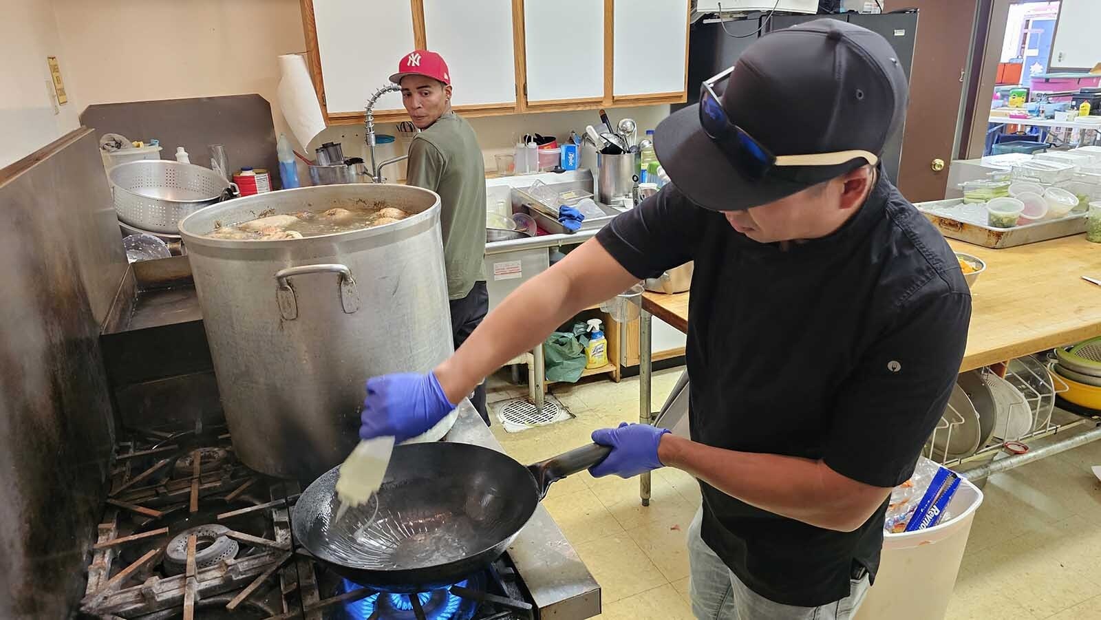 Elvis Nguyen oils a wok to prepare a favorite dish for Fish Creek firefighters — Shaking Beef. It's delicious.