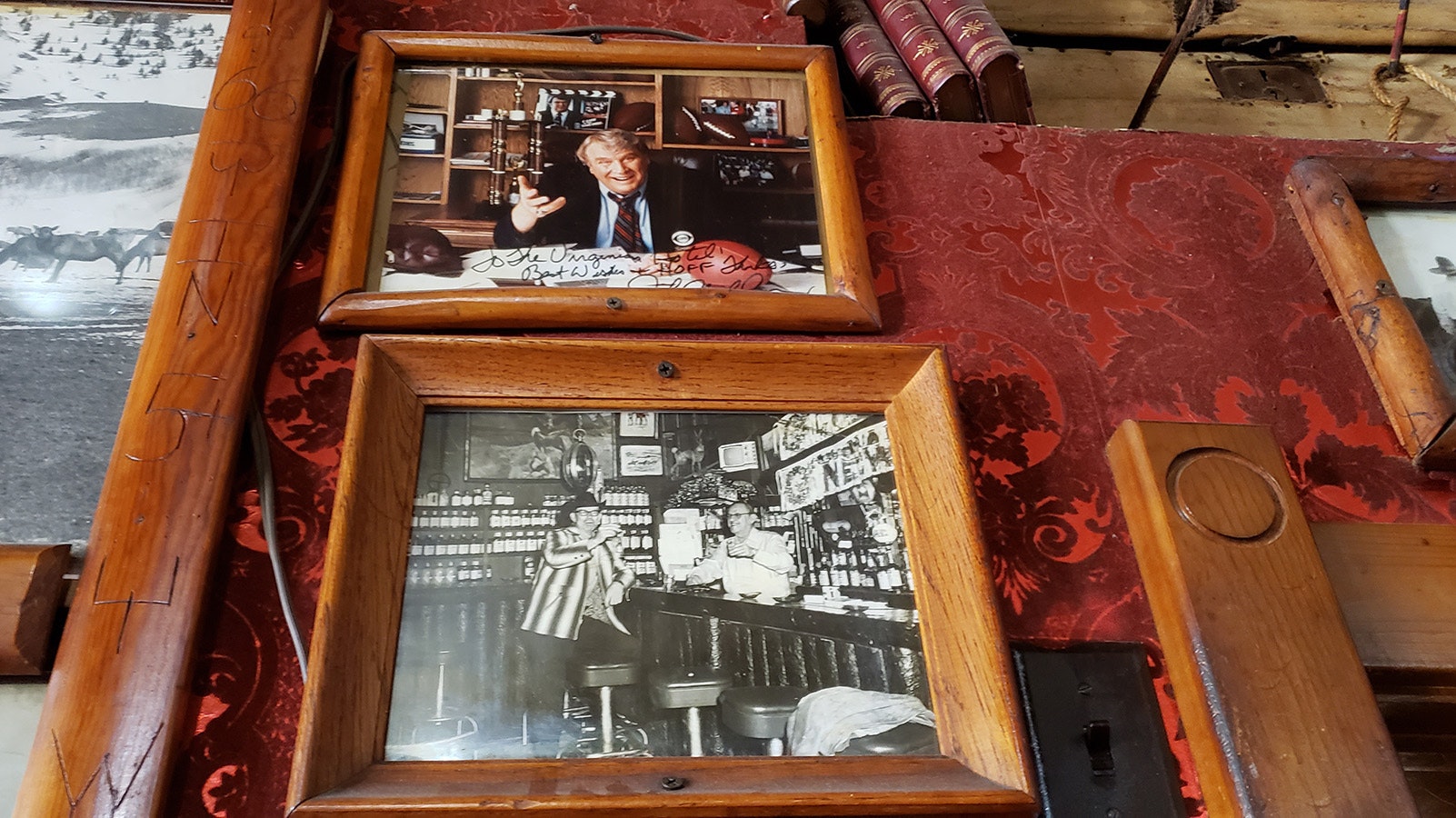 A photo that shows the bar as it used to look at The Virginian under another signed by legendary NFL football coach and analyst John Madden.