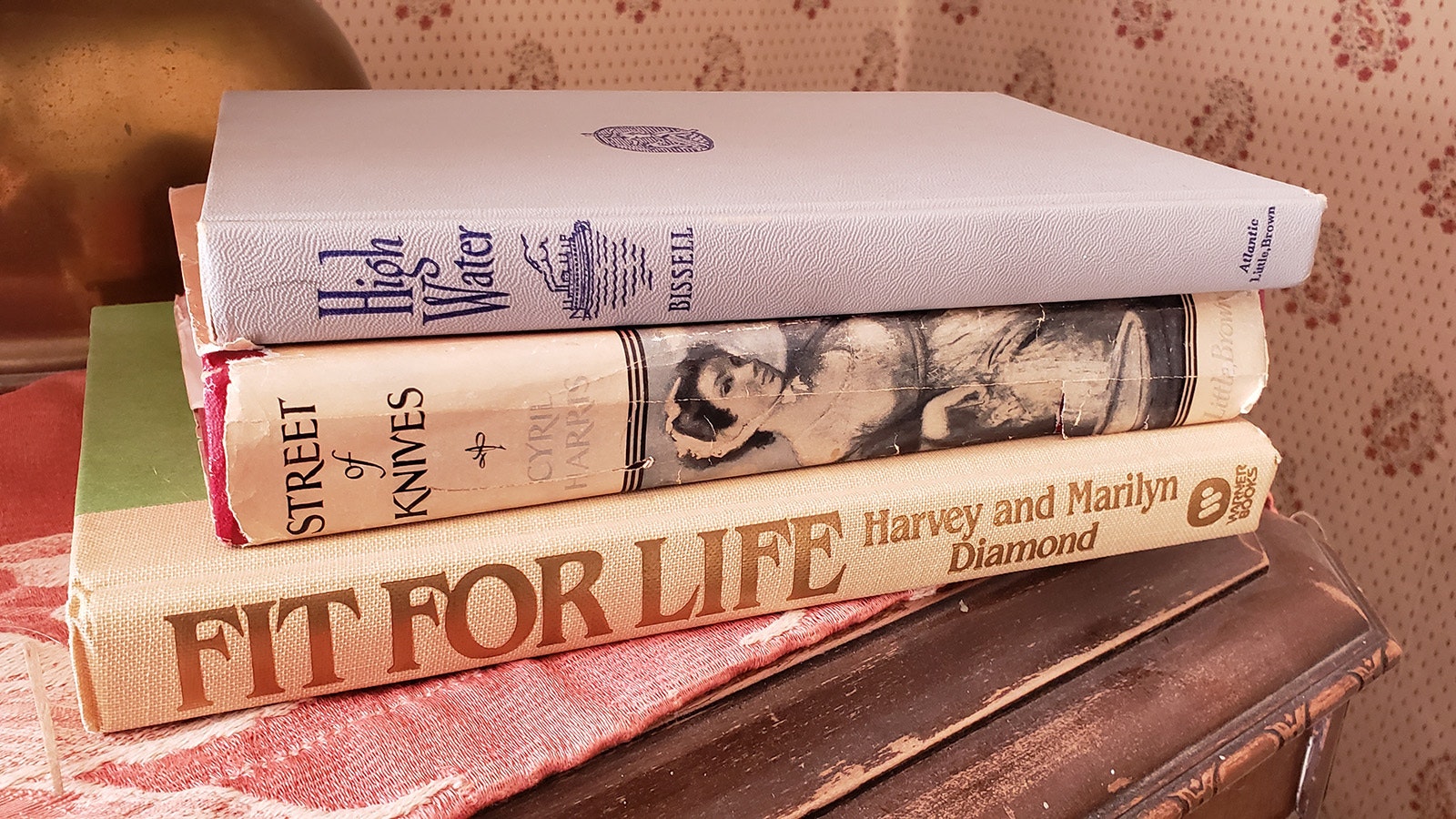 Old books are scattered on bedside tables throughout the hotel.
