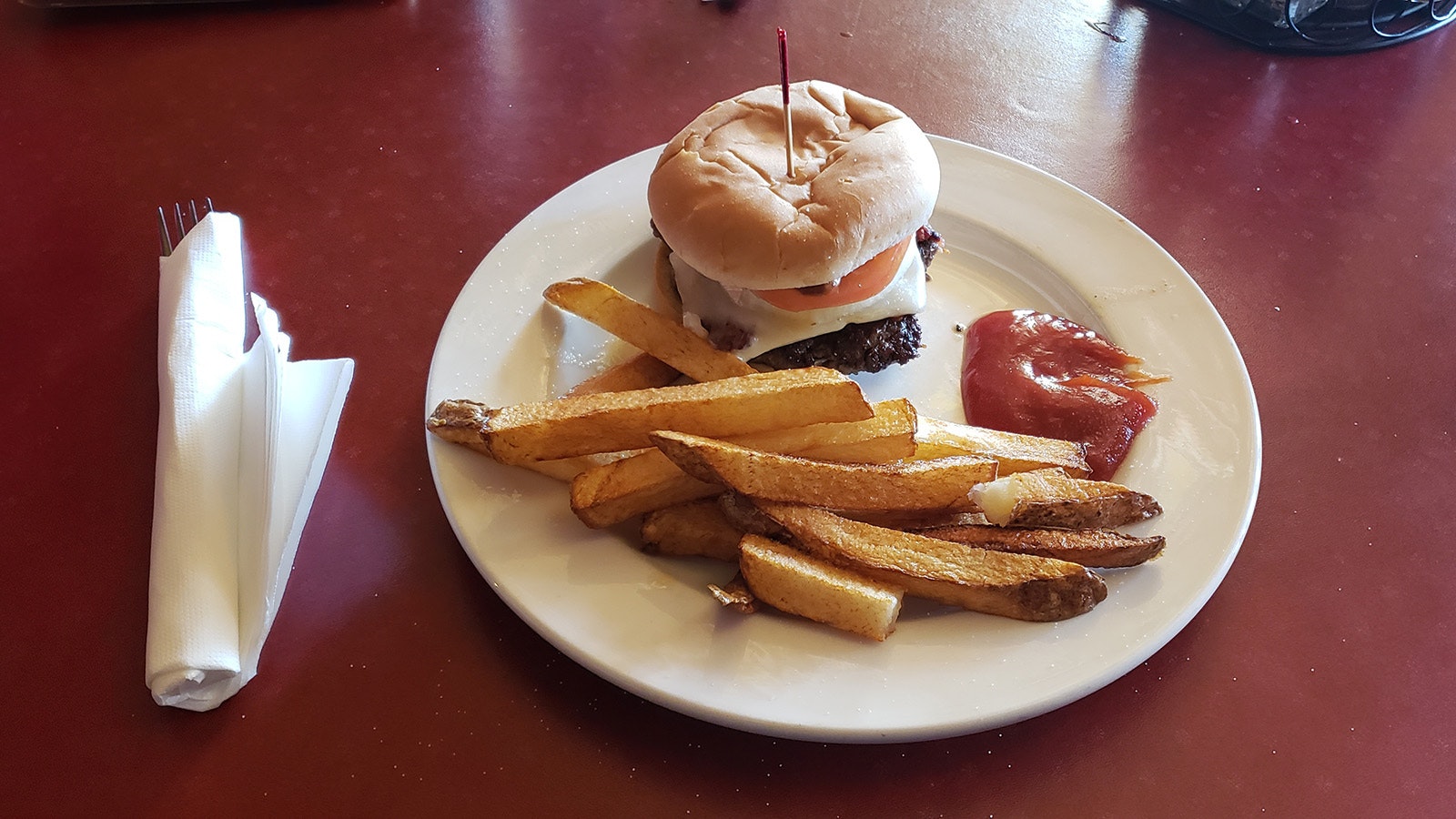 The kitchen turns out a great burger at The Virginian, served with handout home fries.
