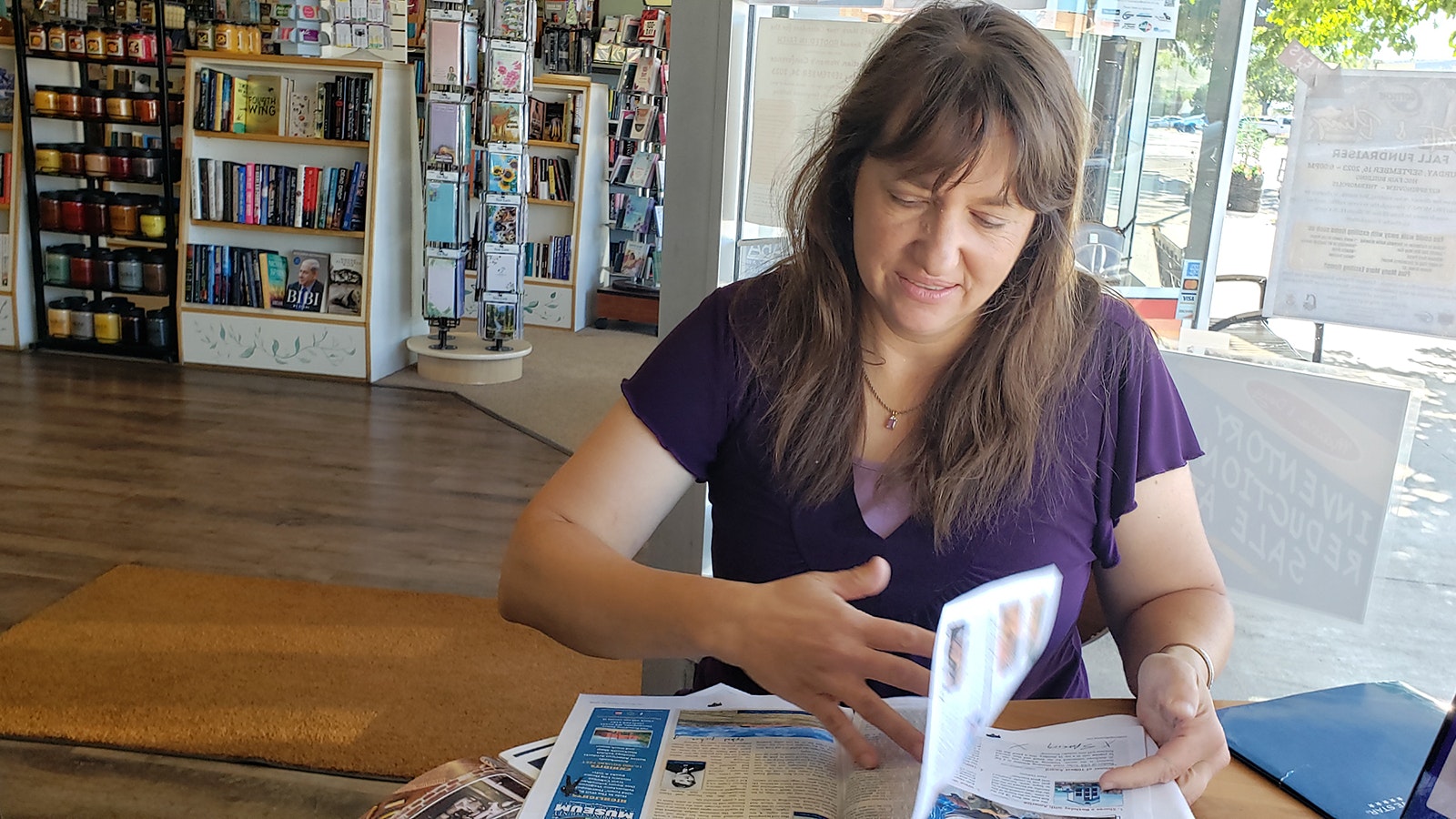 Jackie Dorothy flips through the next upcoming tourism magazine that includes new stories she's uncovered about outlaws in Thermopolis, Wyoming.