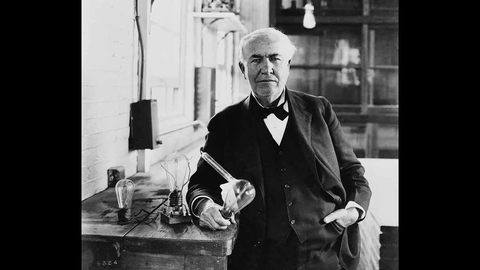 Thomas Edison with one of his light bulbs.
