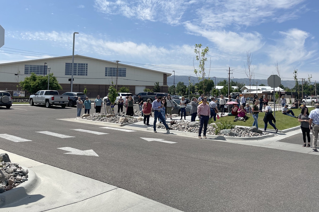 People gather outside the Thyra Thomson State Office Building after a bomb threat prompted an evacuation.